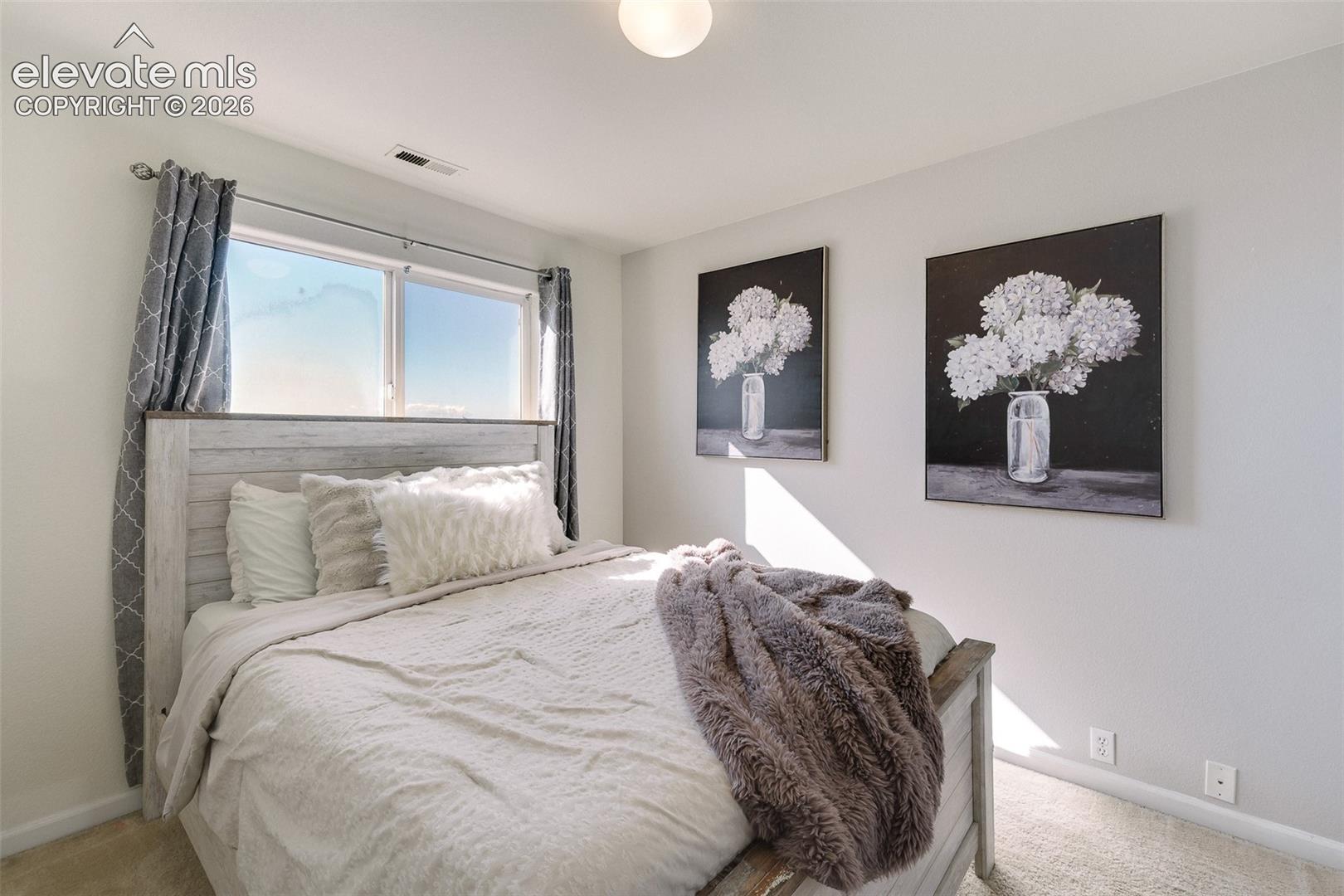 Recessed window with a double pane, light-colored walls, and a ceiling-mounted light fixture
