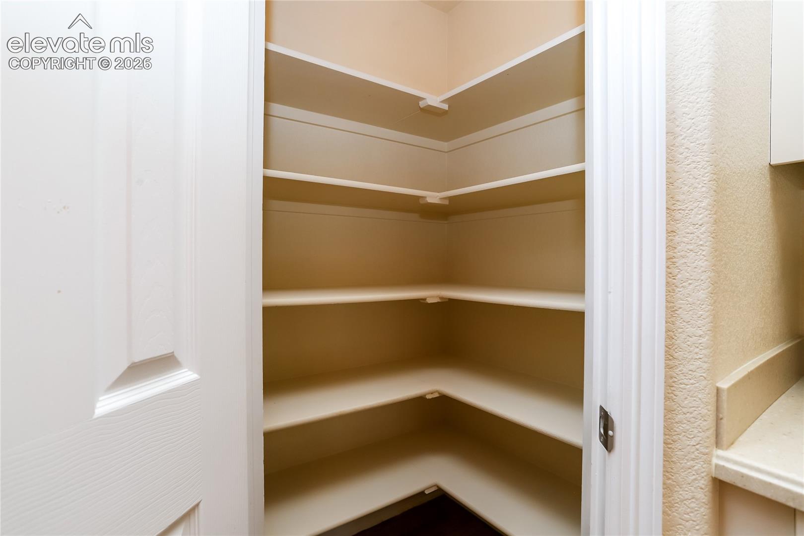 Walk-in pantry provides additional space for kitchen items.