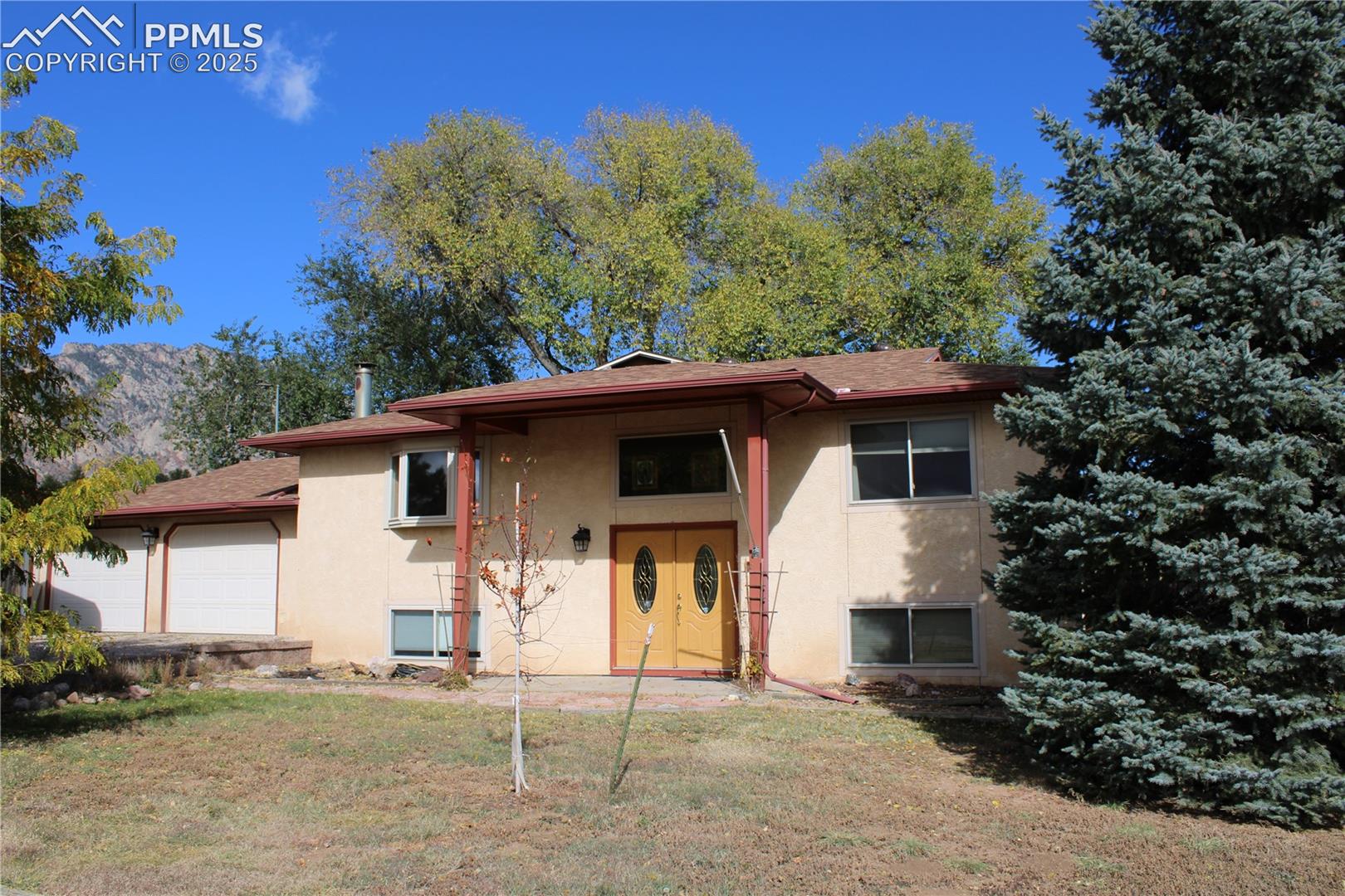 Don't miss this great escape from the city!  You're in the country, but 10 minutes to town and basically across the road from Ft. Carson Gate 5.  Sit on your back deck and enjoy the wildlife while taking in the fantastic views of Cheyenne Mountain.  The hot tub stays with the property and is only about 3 years old, along with the barbeque and portable umbrella.  Perfect for outdoor parties!  This 3-bed, 2-bath home is unique in that the heating is in the ceiling and each room has its own thermostat.  No propane for this property.  The primary bedroom has beautiful wood floors, built-ins, a nice sized walk-in closet and room for a small sitting area.  The spacious family room on the lower level is perfect for gatherings with its wood burning fireplace.  The kitchen will please you with beautiful granite countertops, a counter for people to sit and converse while you're cooking, soft close cabinetry and stainless appliances.  There is plenty of space for RV parking, trailer parking or equipment storing along with the 2-car garage and additional carport.  Evening walks are popular and stargazing is a must!  Please come take a look and see for yourself.