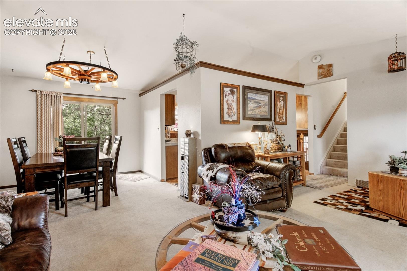 Vaulted ceiling over carpeted flooring