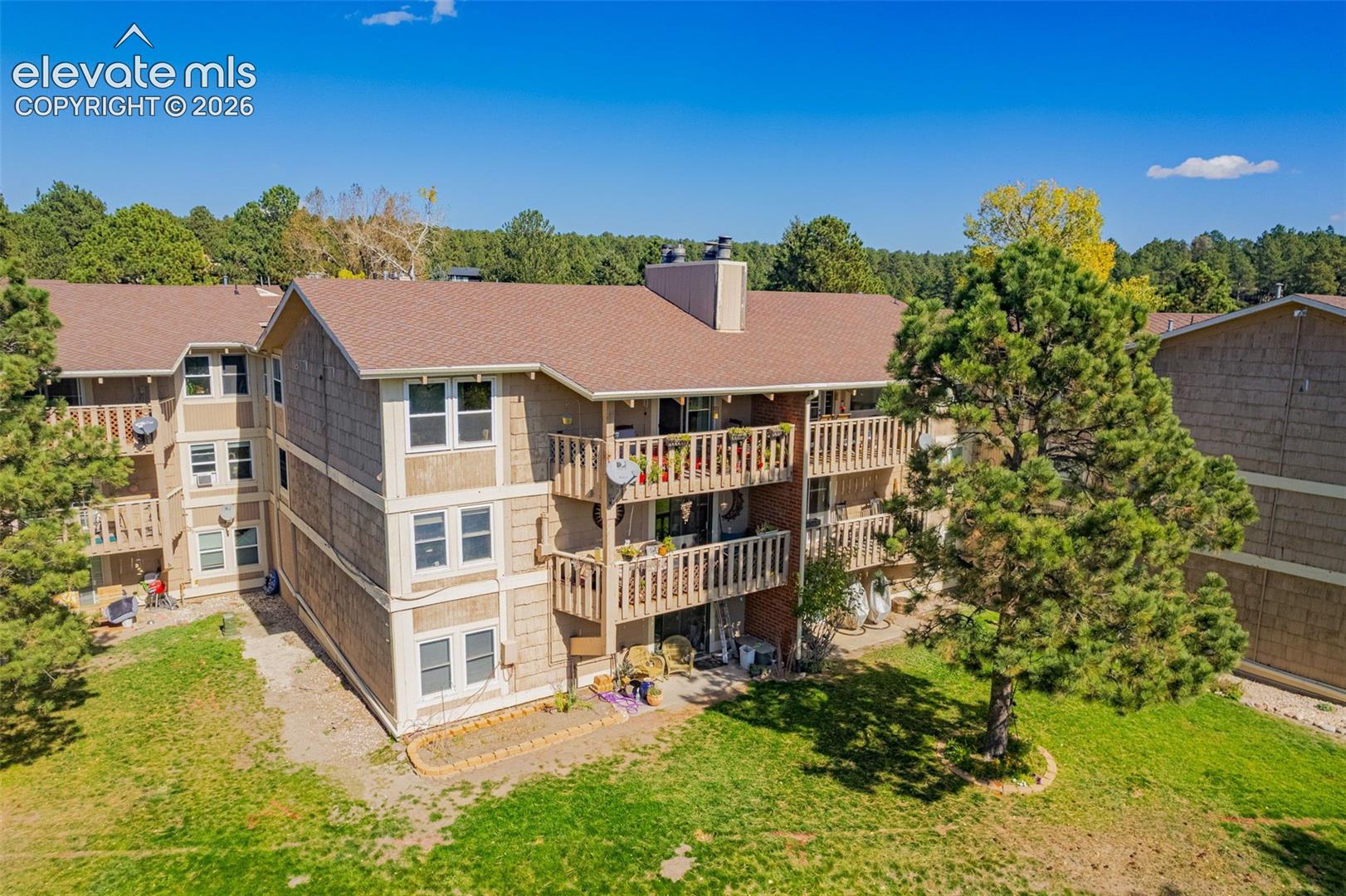 Multi-story exterior to enjoy the lake and wildlife from your upper balcony situated on a landscaped lot with mature pine trees - and all of the landscaping is done for you!!
