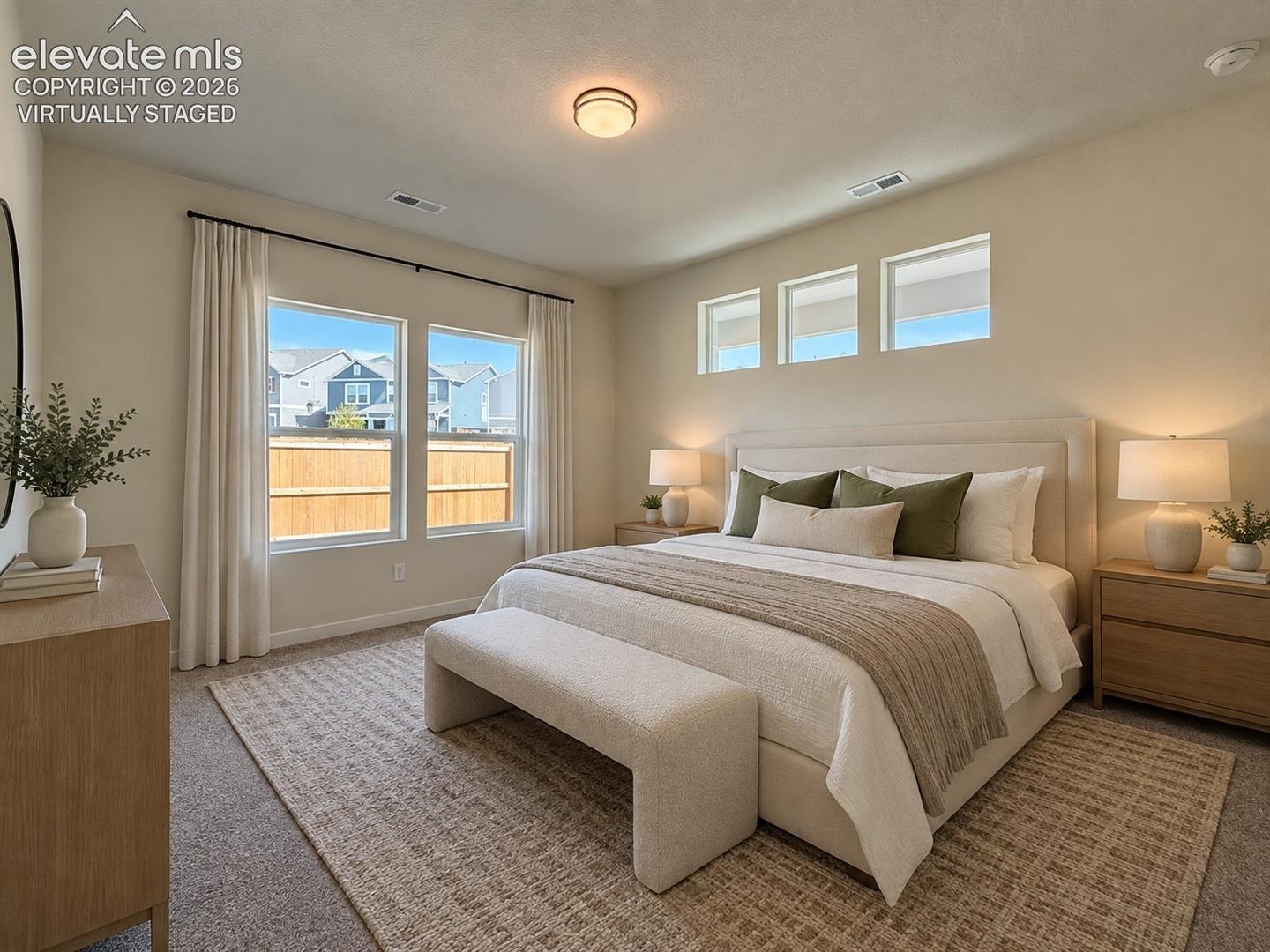 Bedroom with upholstered bed, three small high windows, larger double windows with curtains, and neutral decor — virtually staged