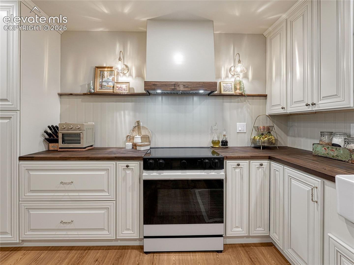 Charming open display shelves with sconces.