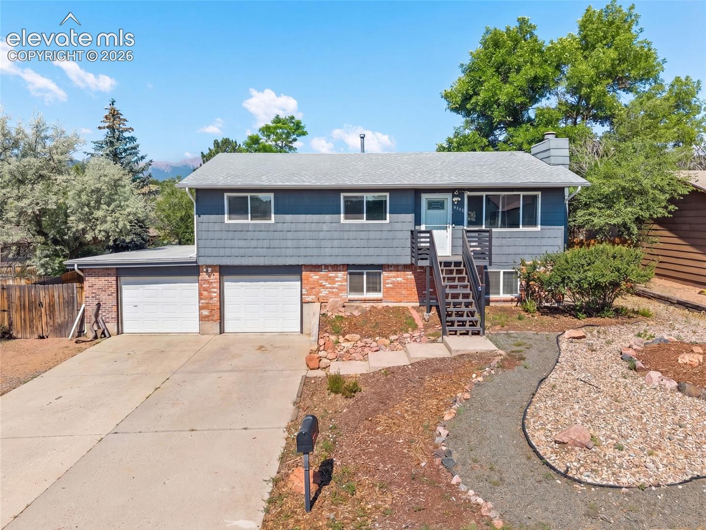 Front exterior featuring a two car garage and inviting entry.