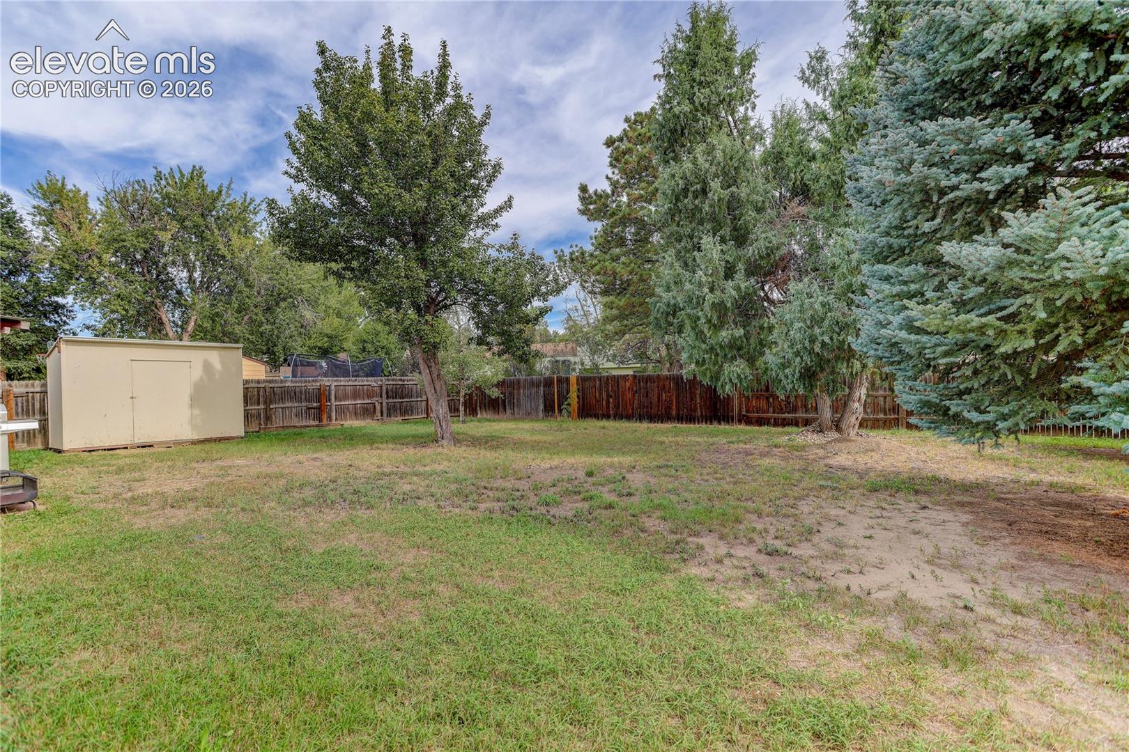 Fully fenced yard w/ mature trees