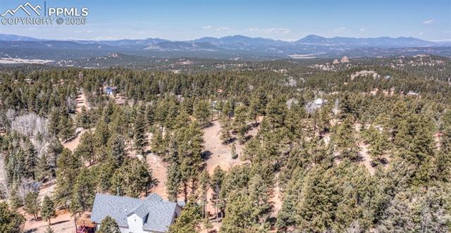 Drone / aerial view of mountains and a heavily wooded area