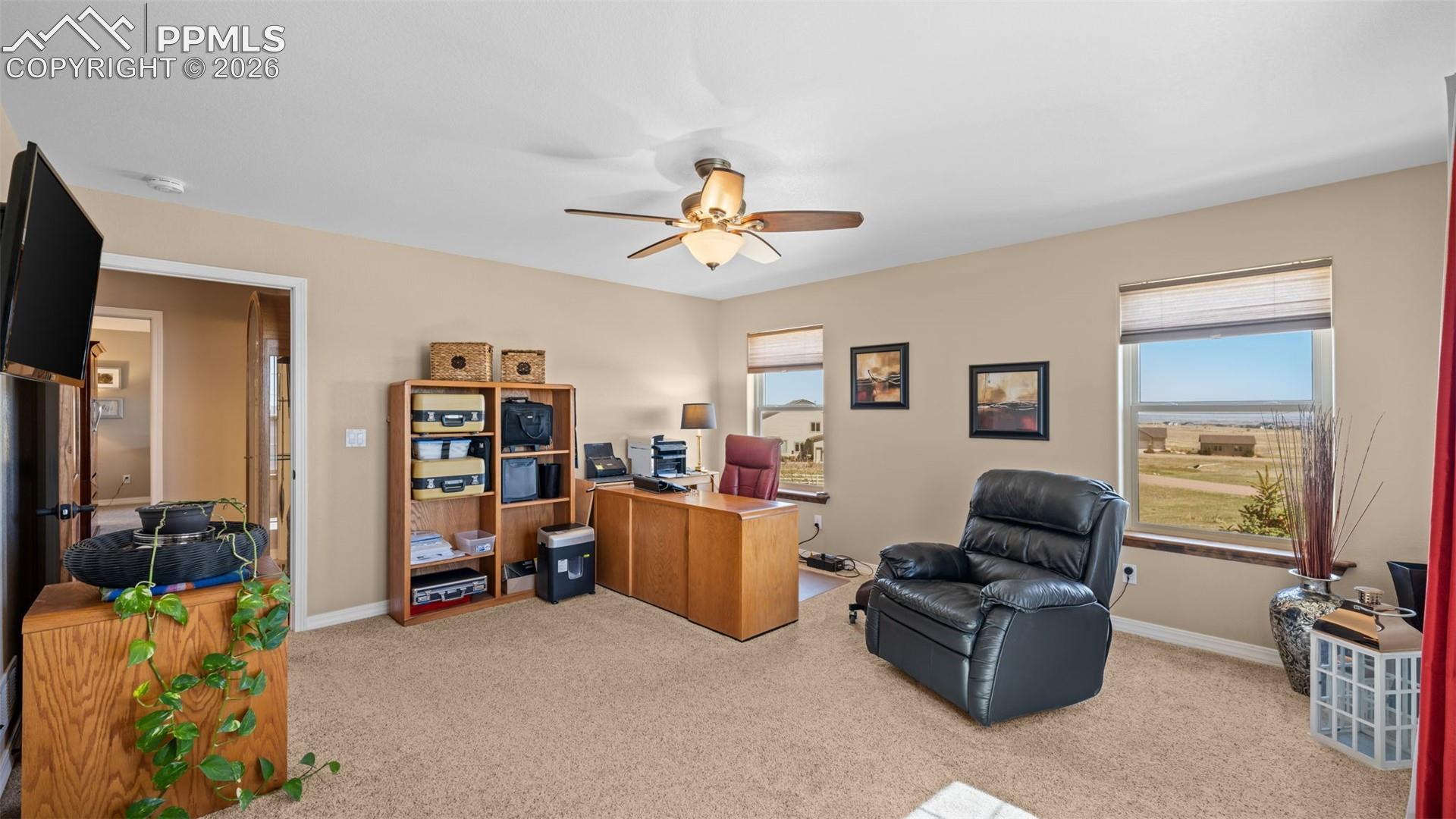 Bedroom, currently used as an office, healthy amount of natural light, and ceiling fan, and double closets