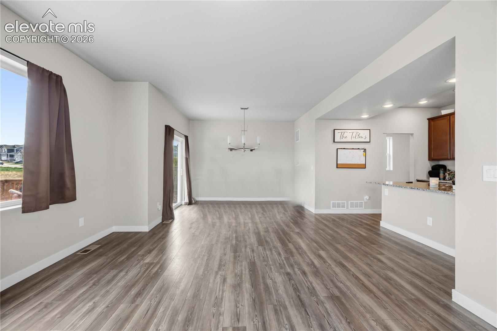 The spacious Living Room flows into the Dining Area and has lots of windows that flood the room with natural light.