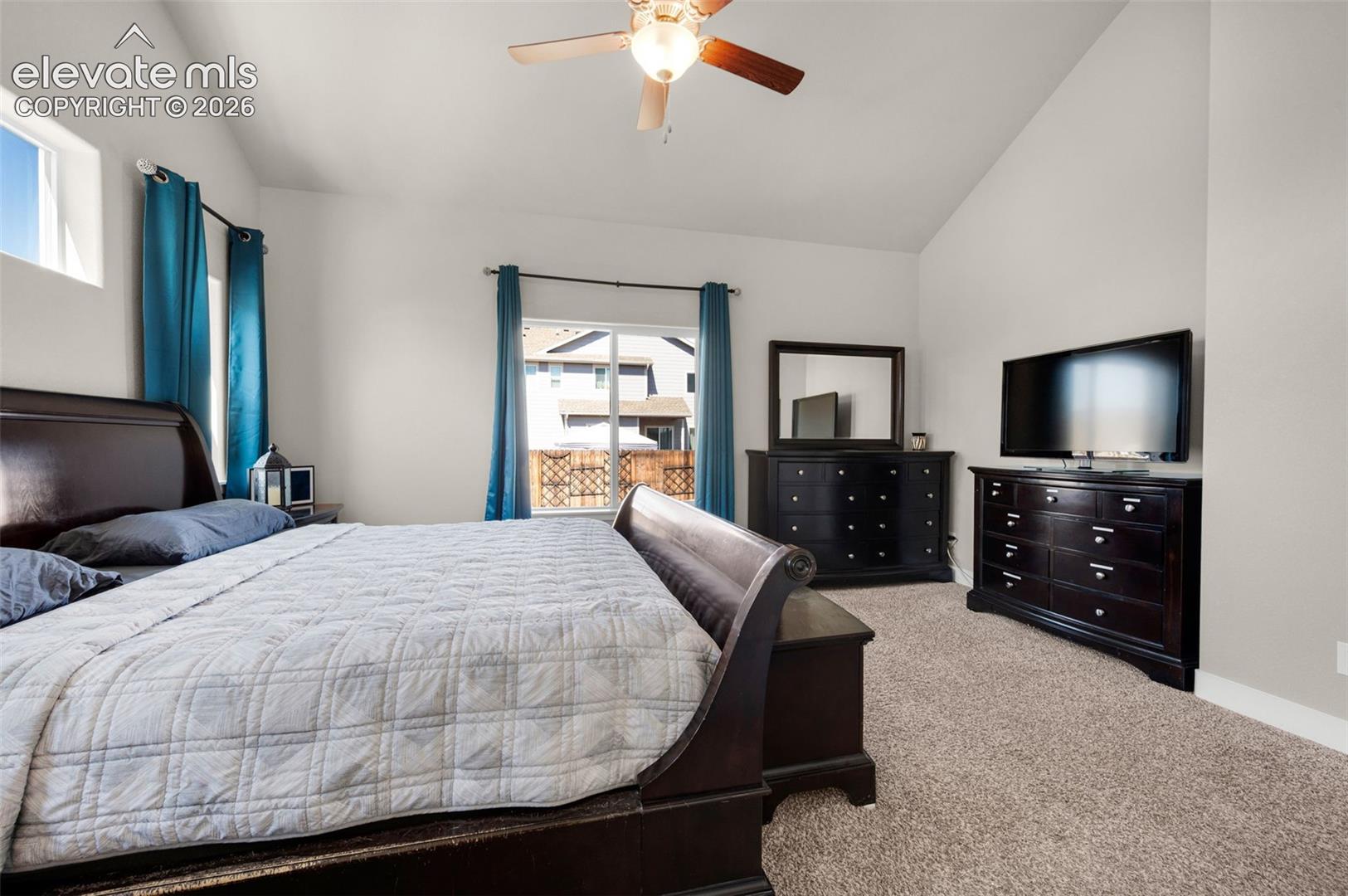 Primary bedroom is carpeted with lots of windows