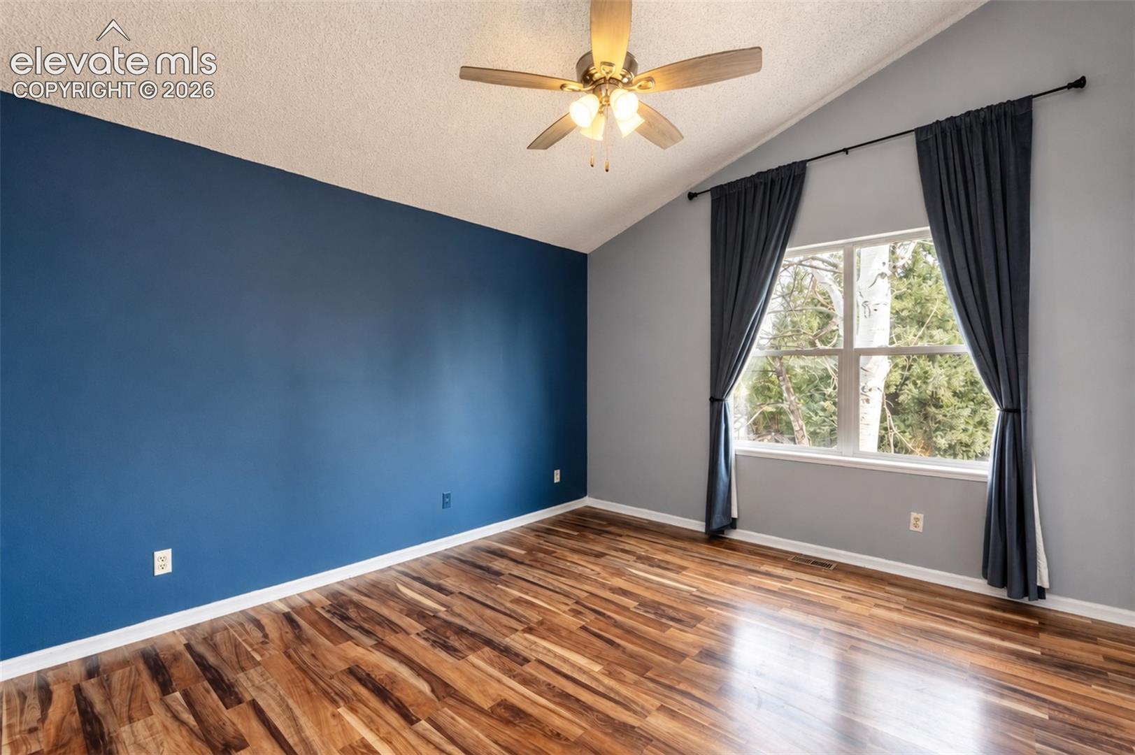Primary Bedroom with Window to Backyard.