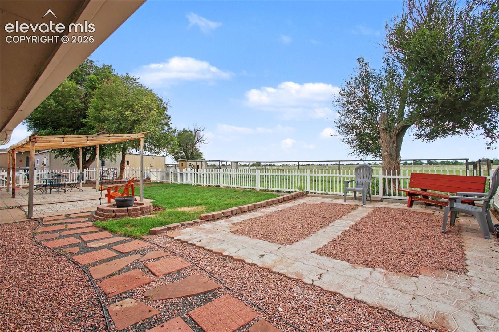 Beautiful concrete paver patio featuring a fire pit, bench, and comfortable seating areas—perfect for relaxing, entertaining, and enjoying the peaceful surroundings and breathtaking views.