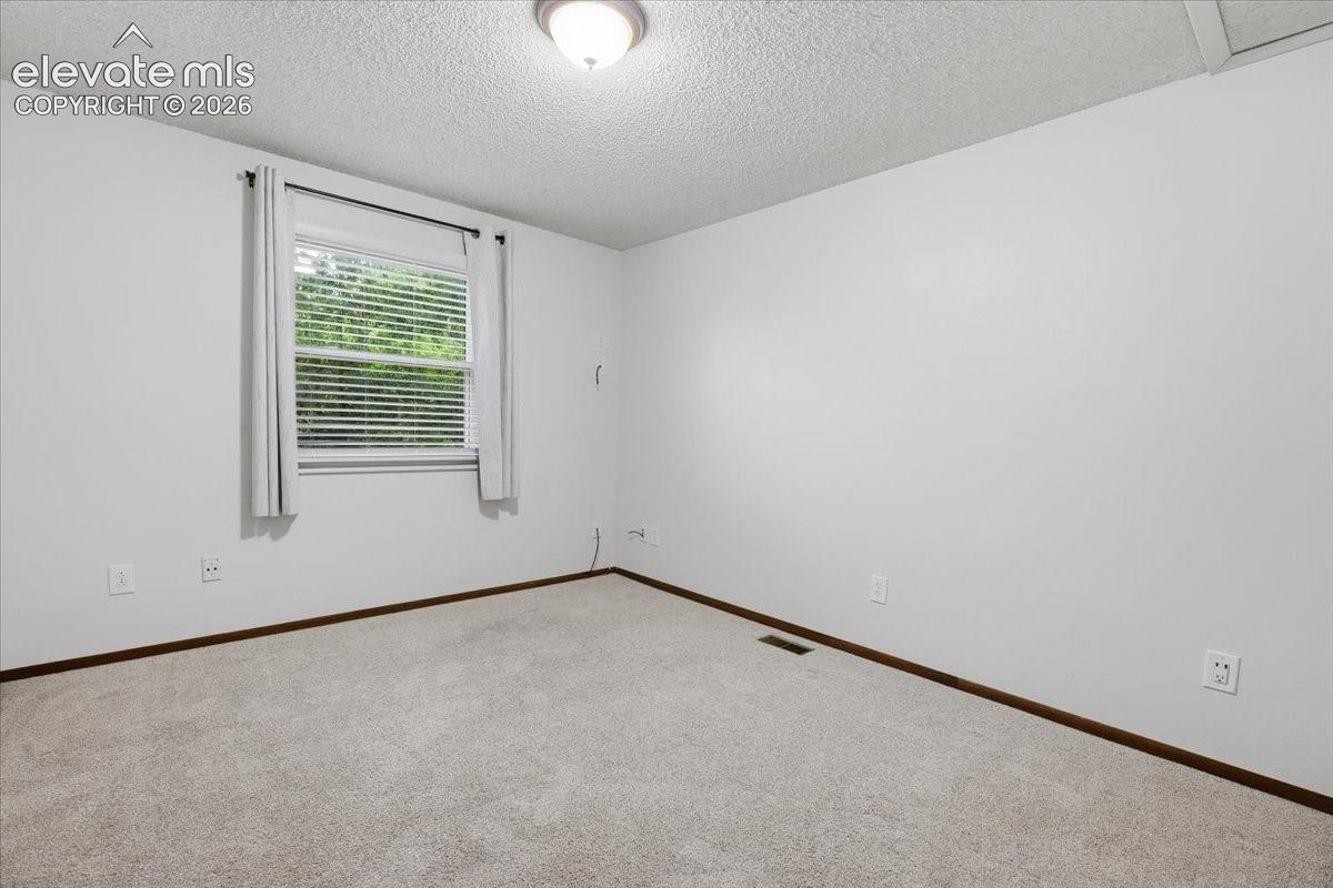 Bedroom 3 - Neutral wall finishes, and overhead lighting
