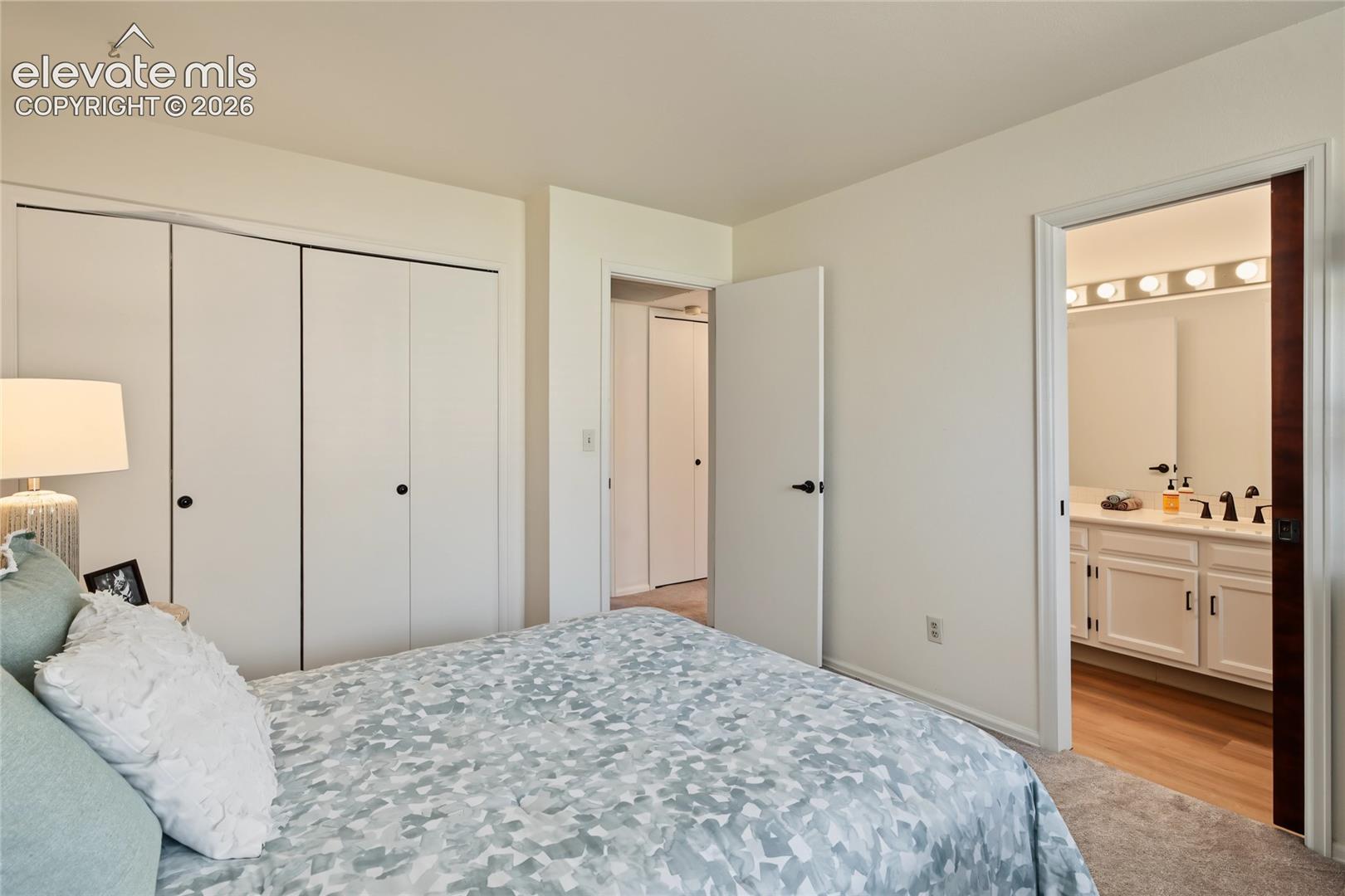 Wall-to-wall carpeting, bi-fold closet doors, and painted walls