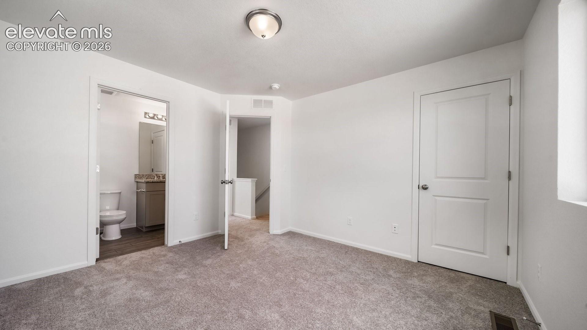 Carpeted flooring, white walls, and a window for natural light
*photos of a model home*