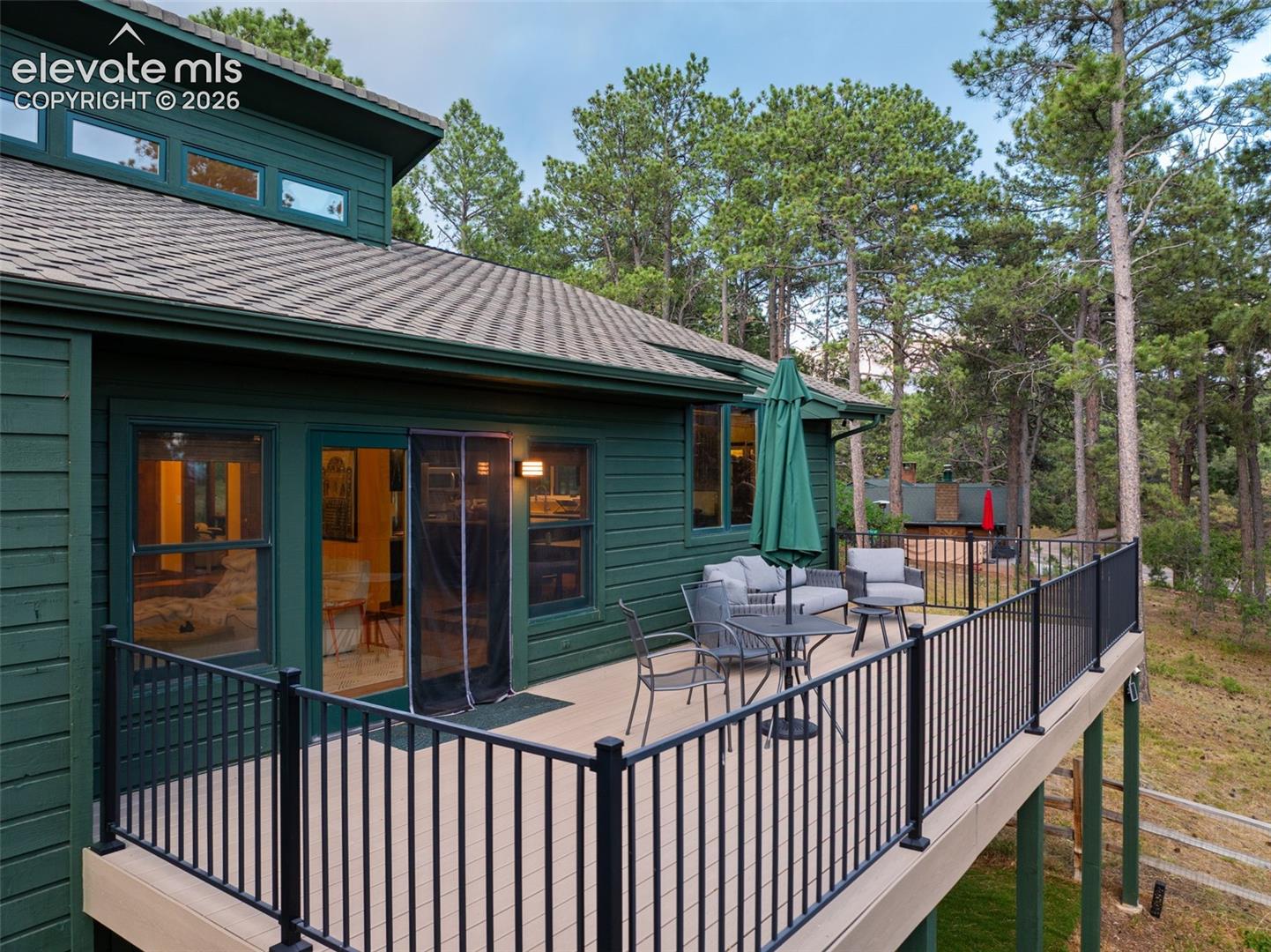 Expansive outdoor deck featuring composite decking and black metal railing