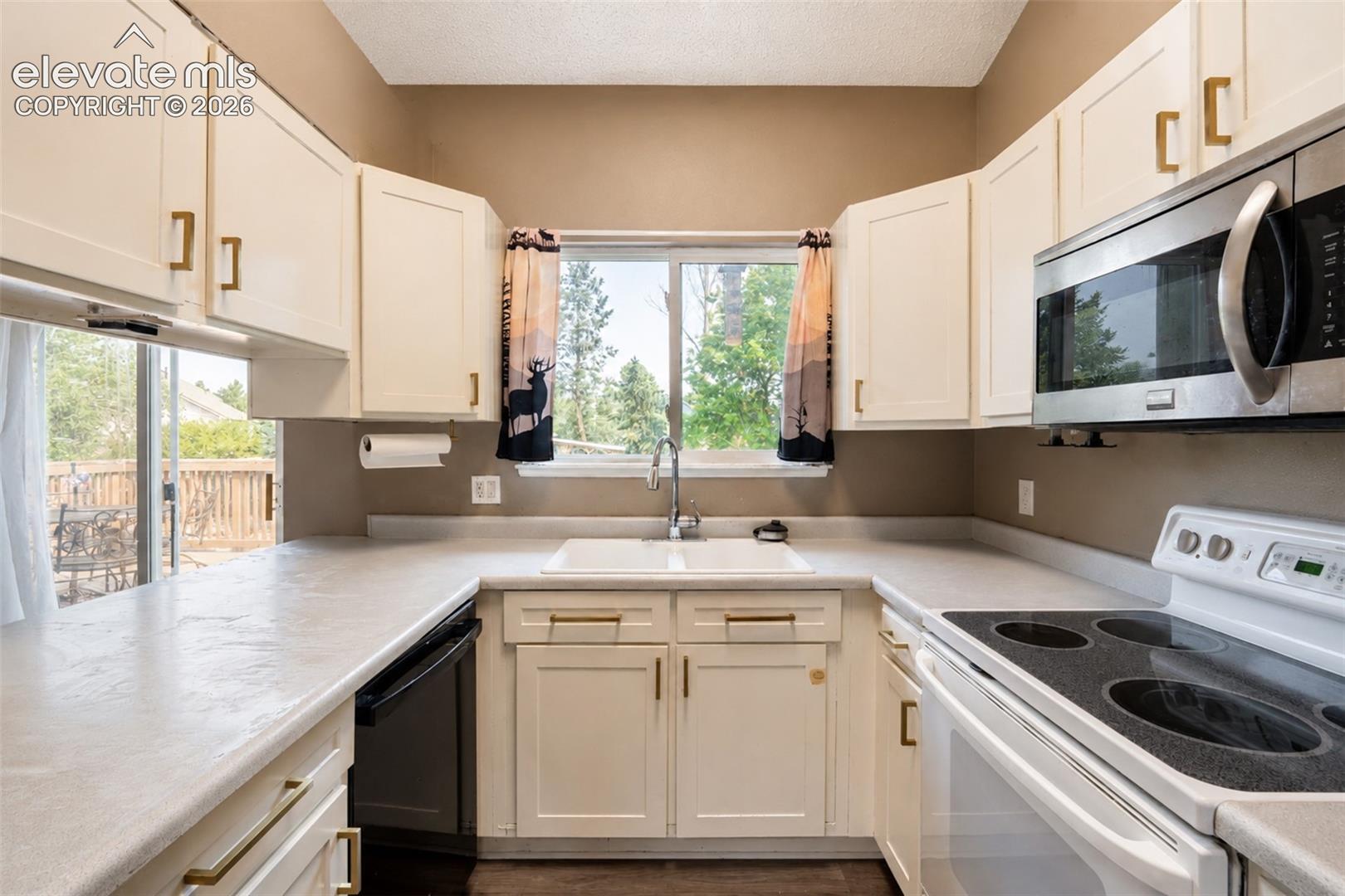 Full View of Kitchen with Window to Backyard.