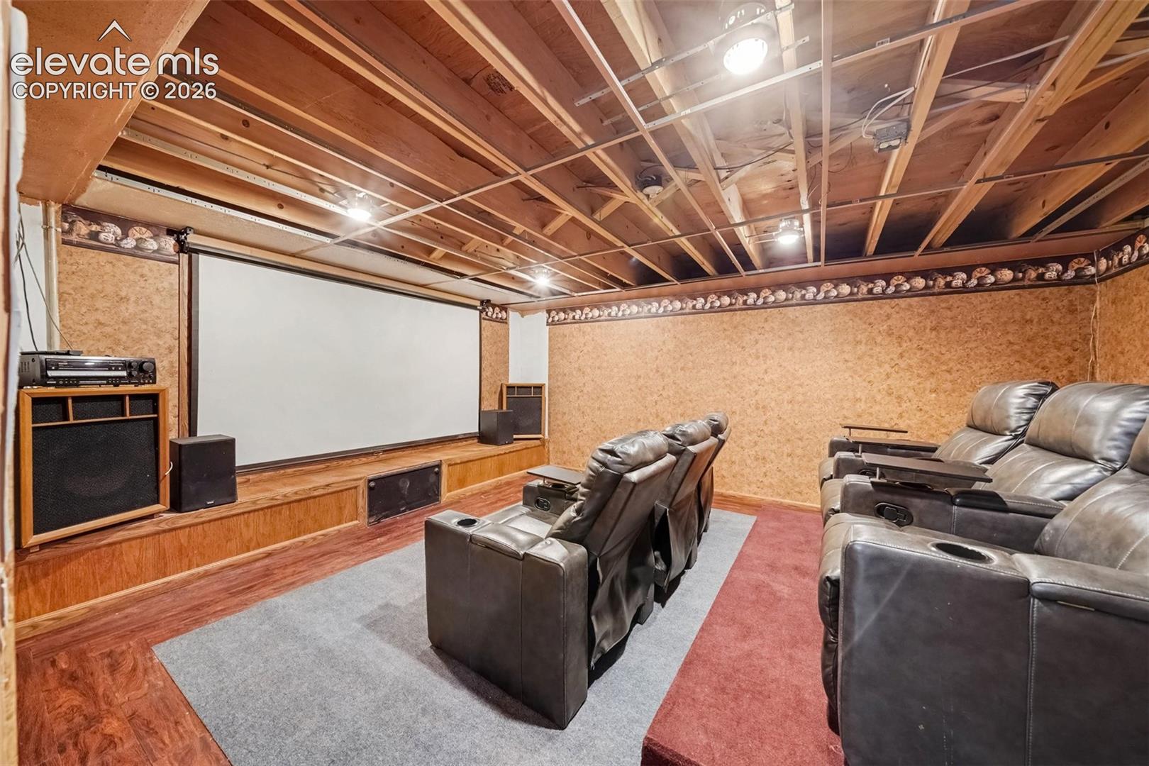 Inviting media room featuring comfortable space for movie nights, entertaining, and relaxing with family and friends. The room includes theater chairs and a screen, creating a dedicated space for enjoying your favorite movies and shows