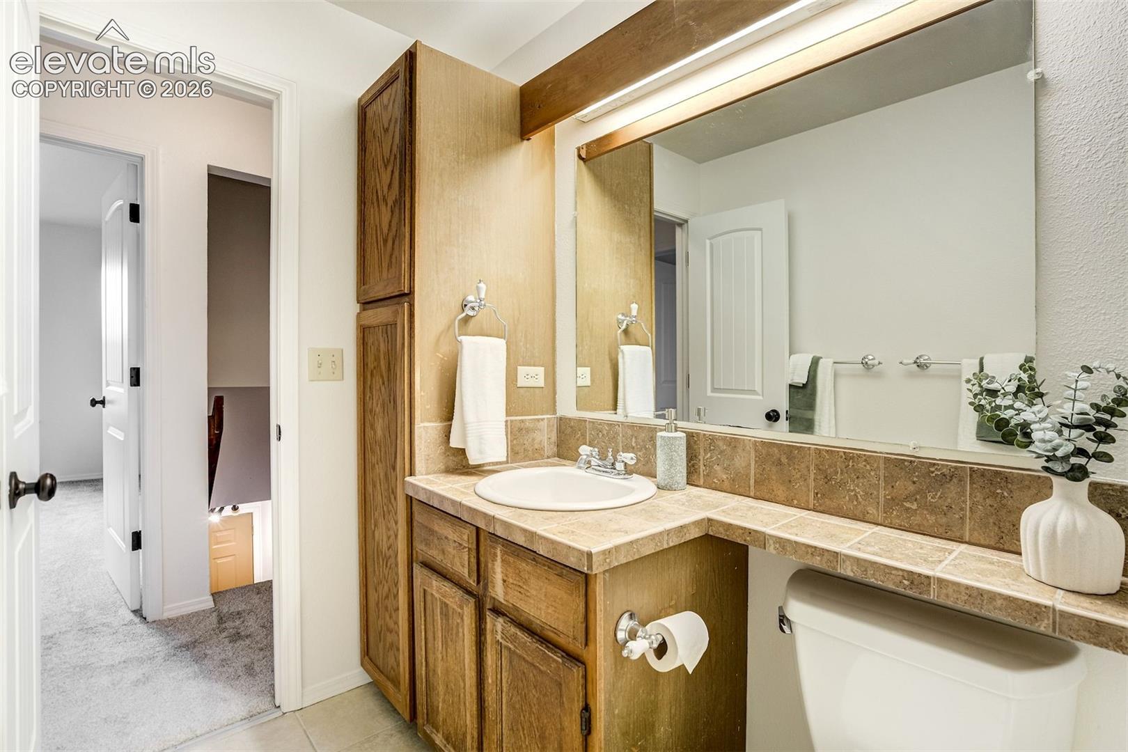 Full upstairs bathroom with large cabinets