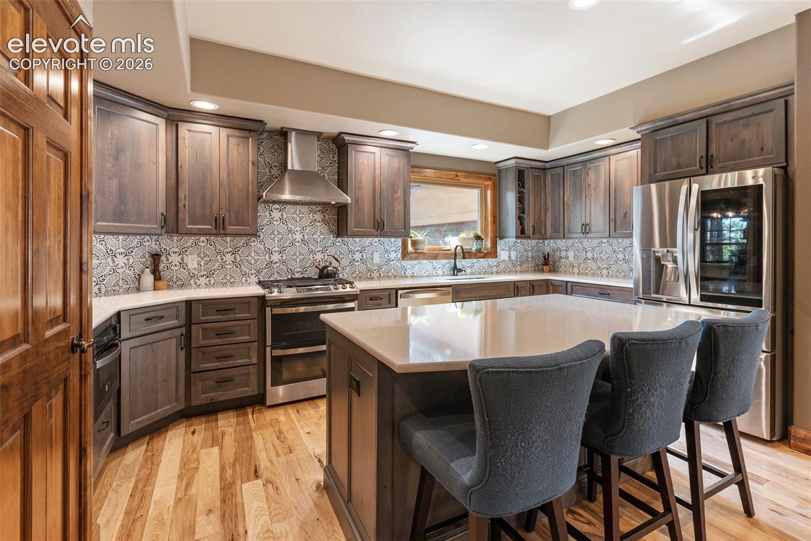 Gas range, draft hood, custom cabinetry.