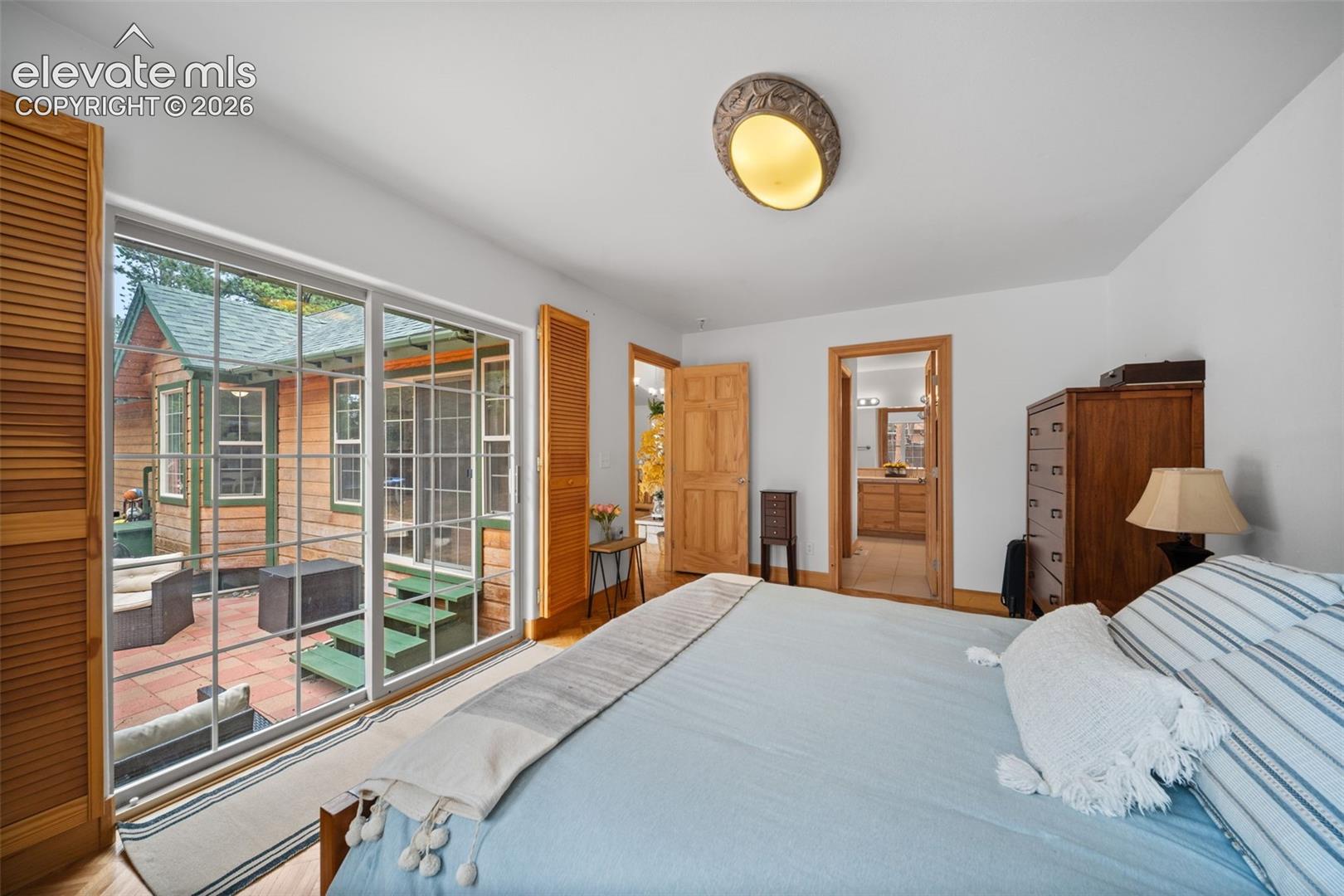 Main level bedroom with private access to backyard patio and ensuite