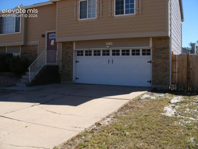 This spacious bi -level home that has 2 living spaces. Three upper level bedrooms with 2 bathrooms. The kitchen has custom cabinetry, stainless steel appliances and a large island that opens to the dining & living room- all of which have dark wood floors. The floors will need some work. On this level is the master bedroom & on-suite master bath. Two additional bedrooms and a  full bath complete the upper level. Lower level has another bedroom, 3/4 bath, laundry & large family room. This home does have central air. Oversized 2 car garage.  The wood deck is just off the dining room and leads to the fully fenced, level backyard. There is a large storage shed. Located on  a cul-de-sac, this home is conveniently located close to schools, shopping, trails, and Fort Carson.