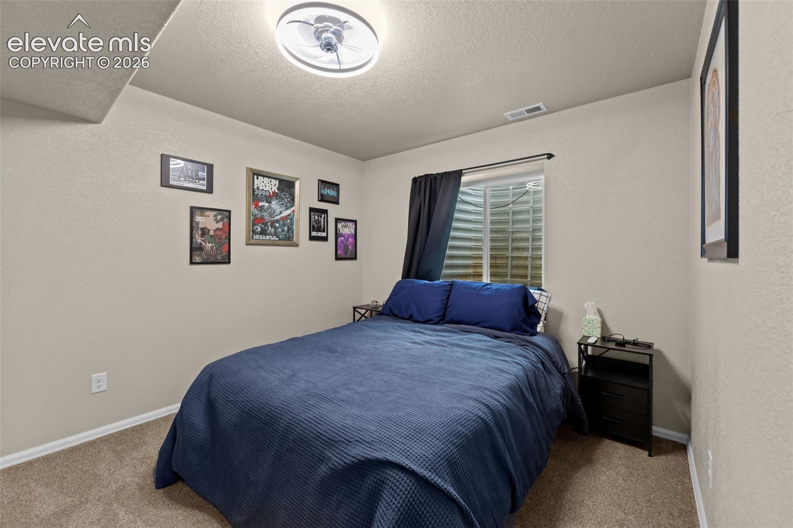 Neutral wall tones, recessed window, and light-colored carpeting