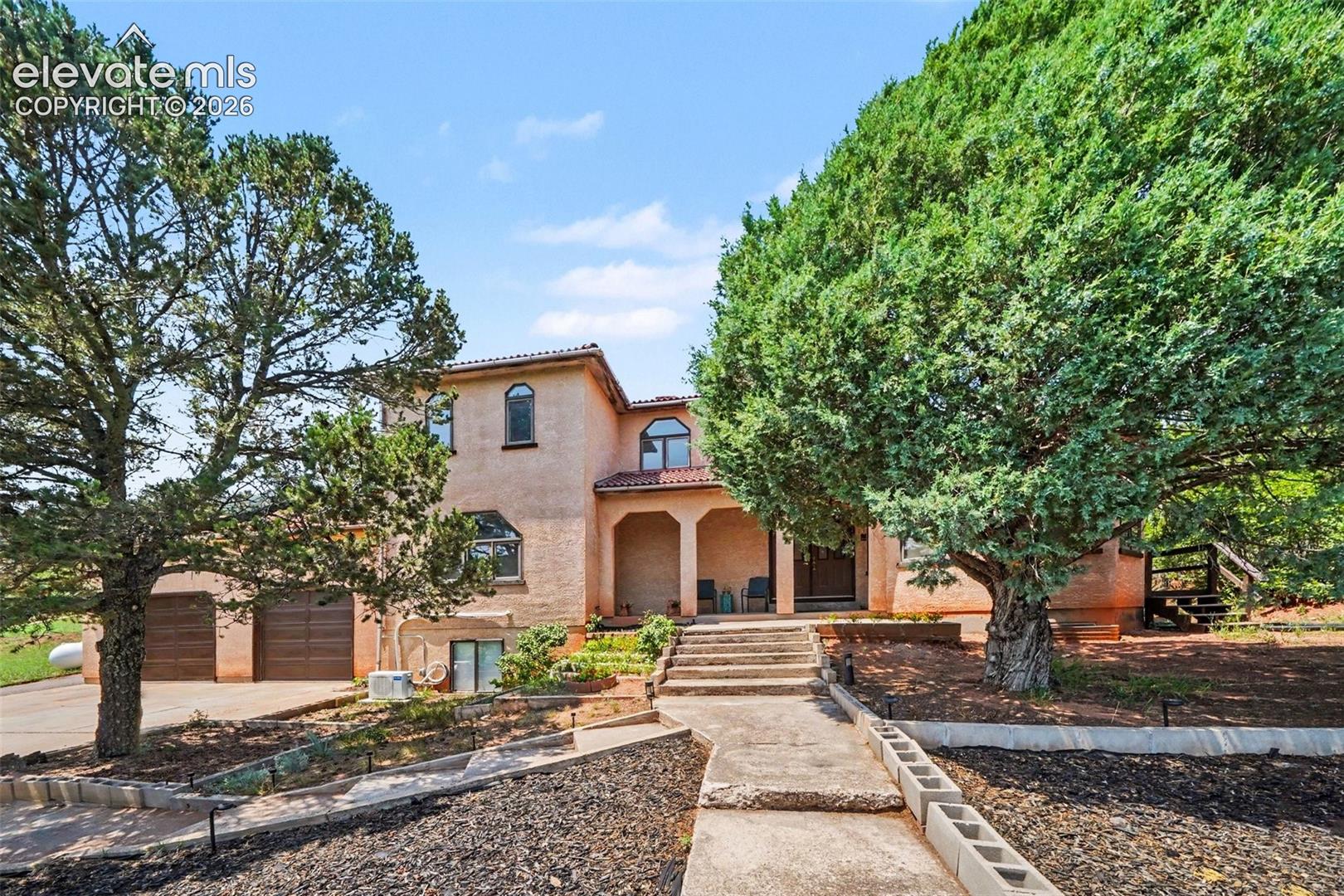 Steps lead to the front door, surrounded by the beauty of the Red Rock Valley setting