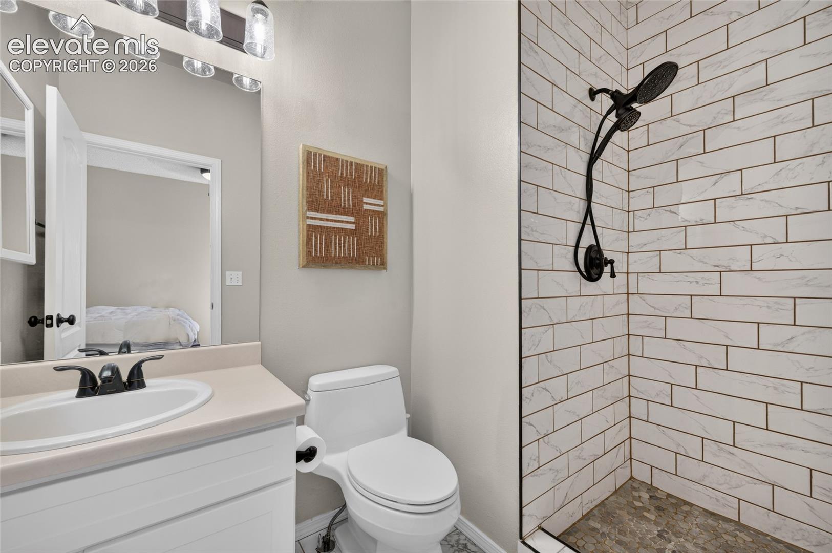 Primary bath redone with tiled floors, tiled shower surround, and new fixtures