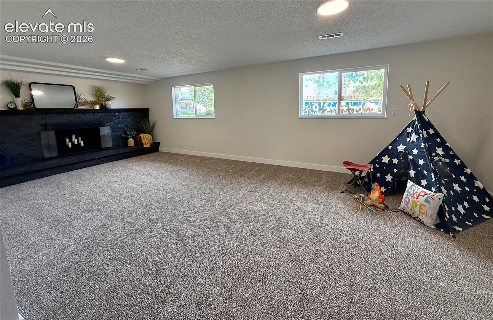 Large garden level rec room with wood burning fireplace