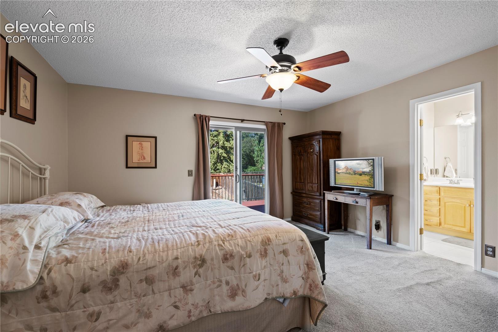 Plush carpeting, ceiling fan with integrated lighting, and direct access to an outdoor balcony