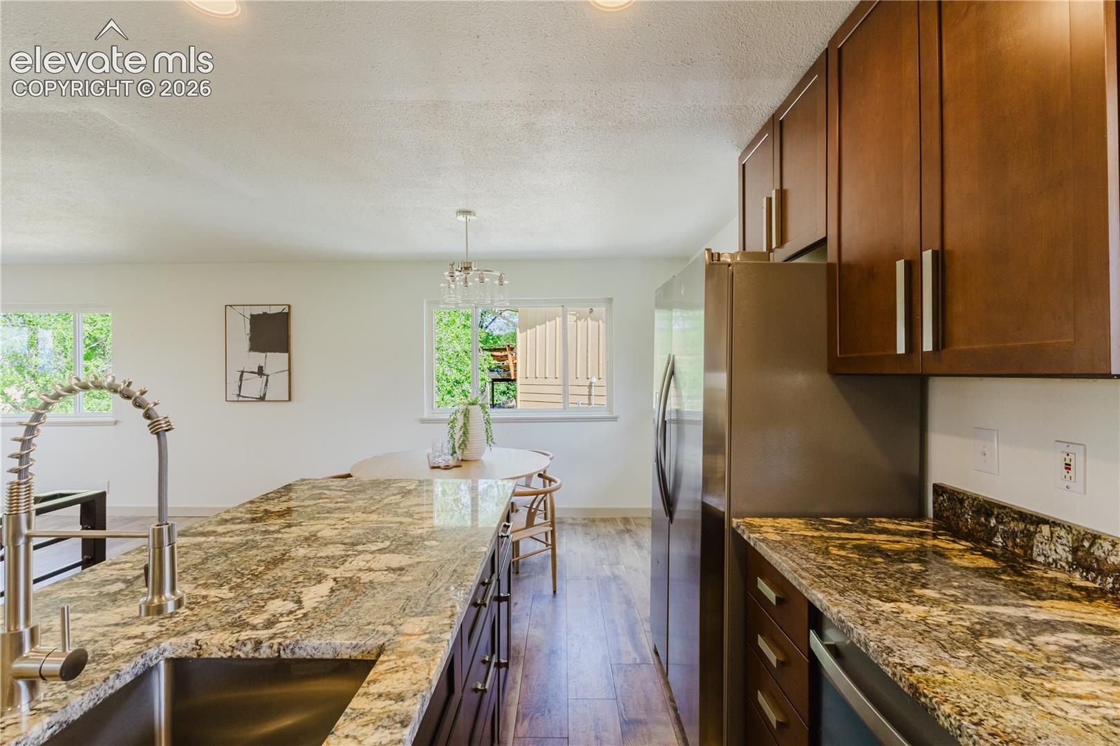 Kitchen featuring wood-finish flooring, recessed lighting, and white walls