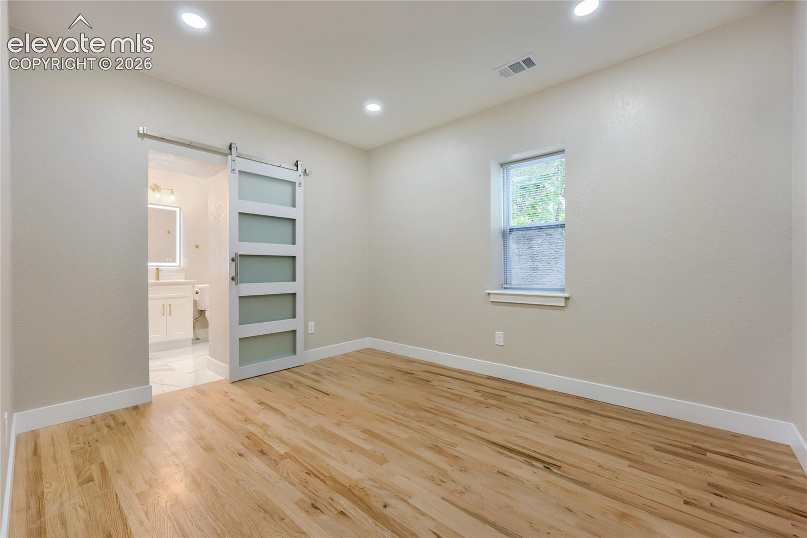 The generously-sized primary suite is your warm-lit, private retreat. It is separate from the secondary bedrooms. It offers a calm space to rest/recharge, and a beautiful spa-inspired ensuite bath.