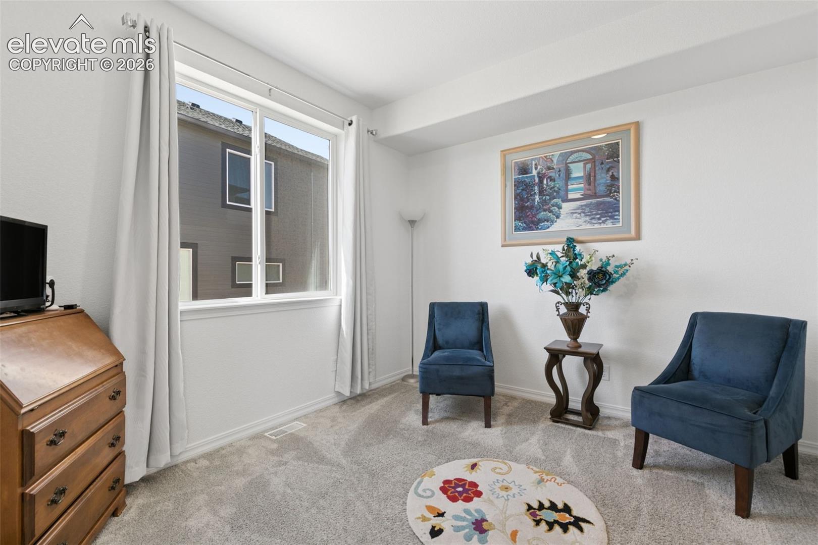 Expansive window with white trim, light gray carpet flooring, and neutral wall tones