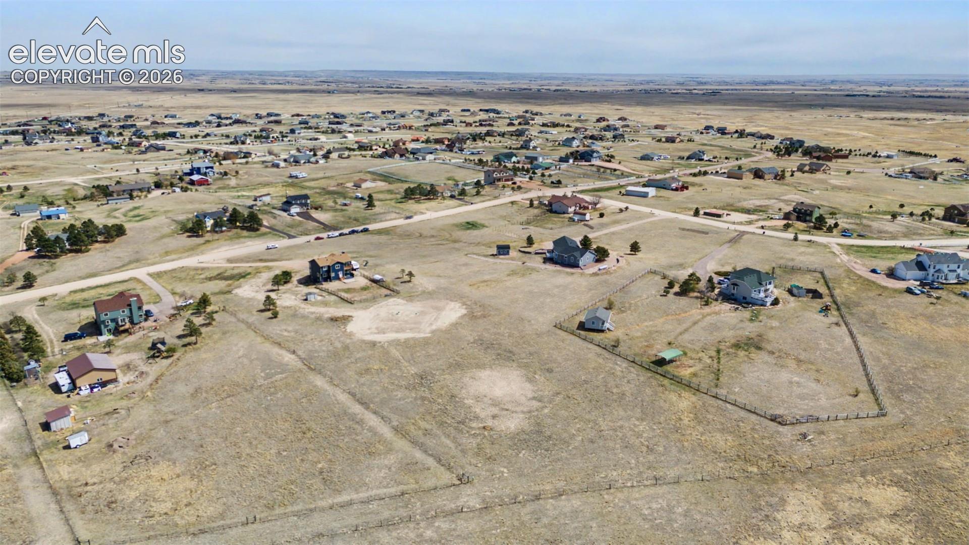 Aerial perspective featuring expansive acreage, open terrain, and defined lot boundaries