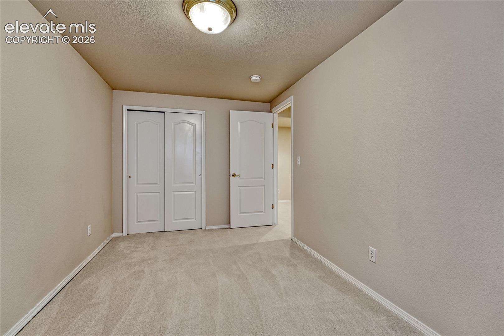 An additional lower-level bedroom provides excellent space for guests, hobbyists, or specialized storage
