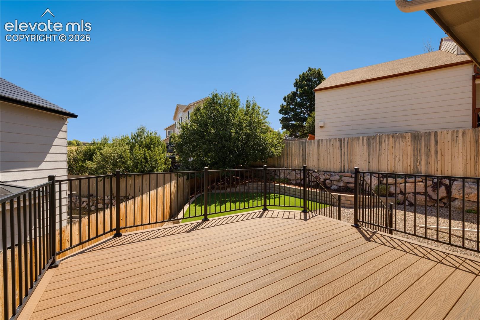Backyard has new 12 x 14 composite deck, artificial turf, and landscaping and an awning on back of house