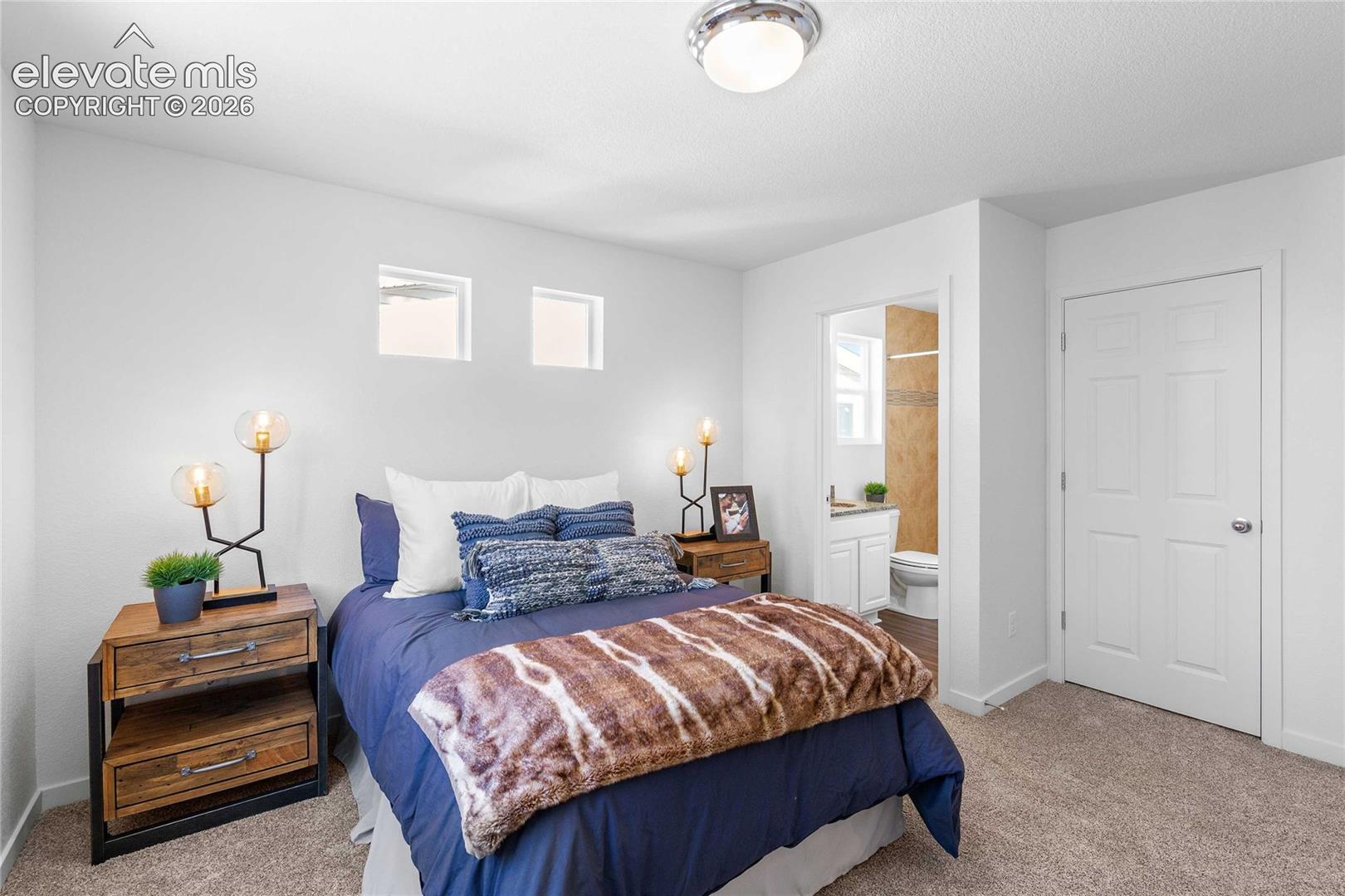 Plush carpet flooring, white walls, and a ceiling-mounted light fixture
*photos of a model home*