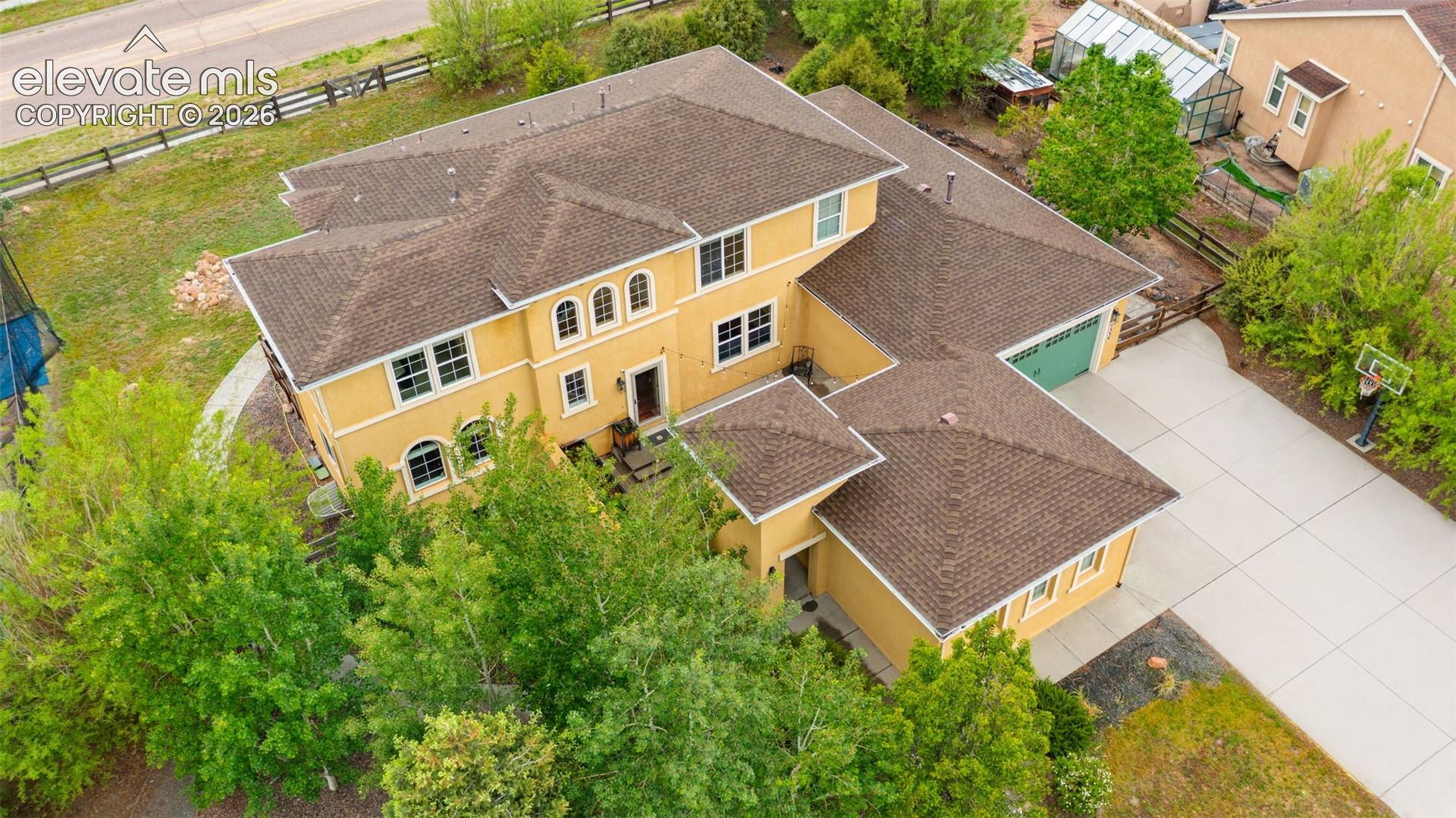 Multi-story residence featuring a stucco exterior and a hip roofline