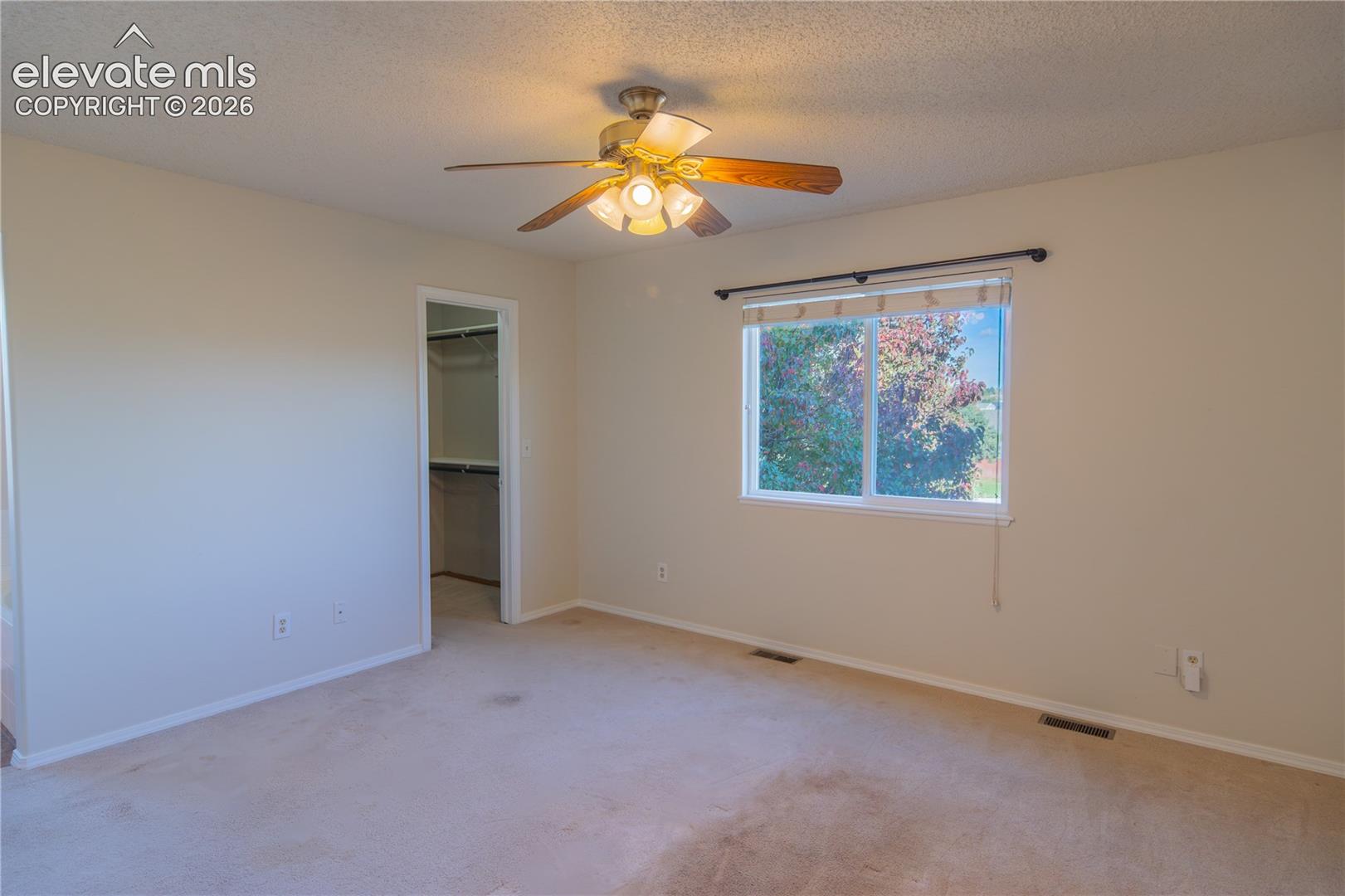 The primary suite features a spacious walk-in closet with built-in shelving.