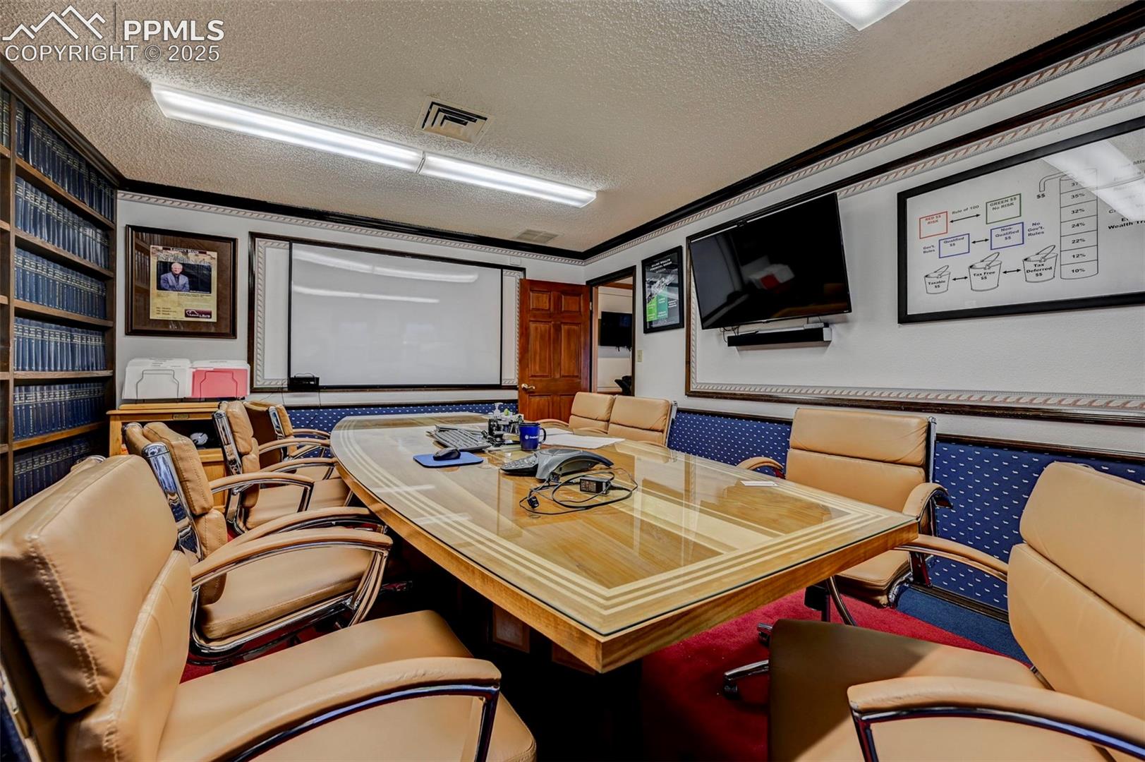 Office area featuring a textured ceiling and ornamental molding