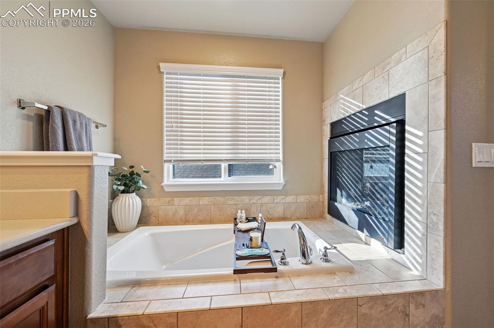 Full bath featuring a garden tub and vanity