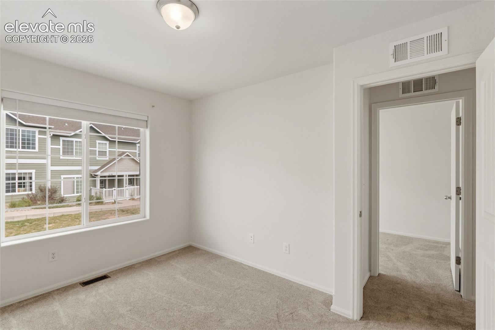 Large vinyl windows let in great natural light, making this upper-level room feel open and inviting