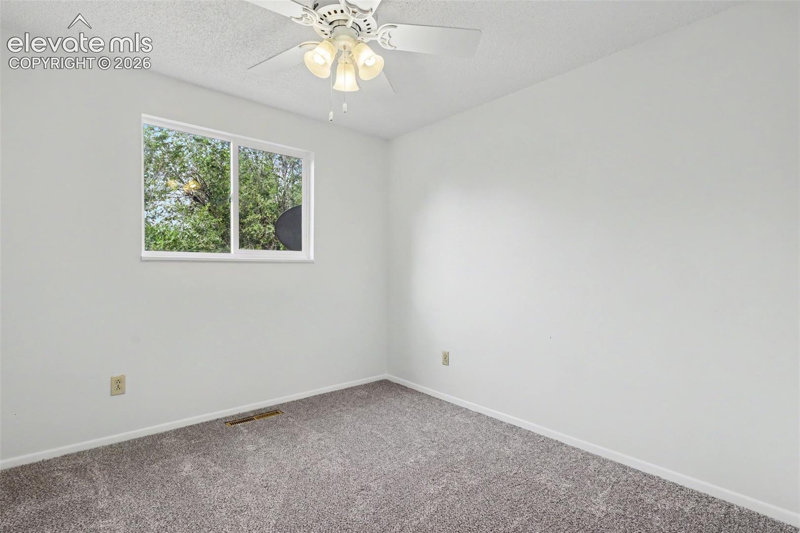 Upper level bedroom with closet storage and updated flooring.