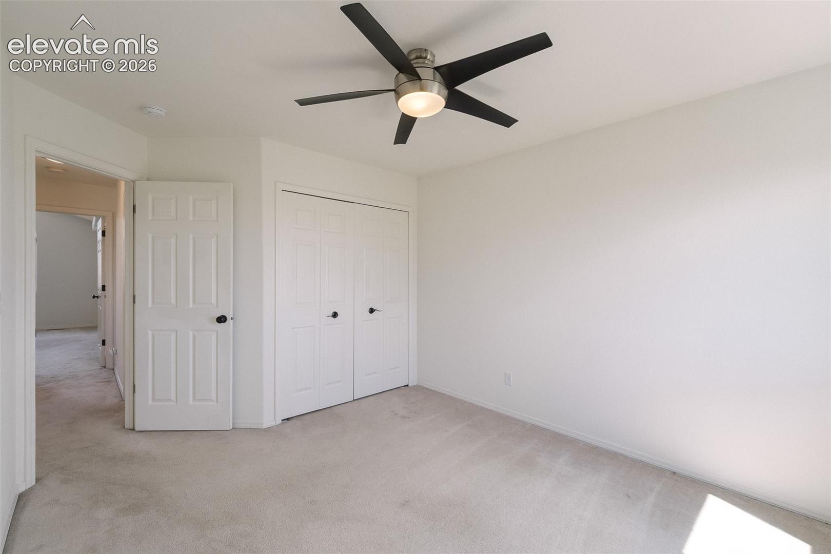 Recessed lighting, ceiling fan with light fixture, light neutral wall paint, bi-fold closet doors, and light neutral carpet flooring