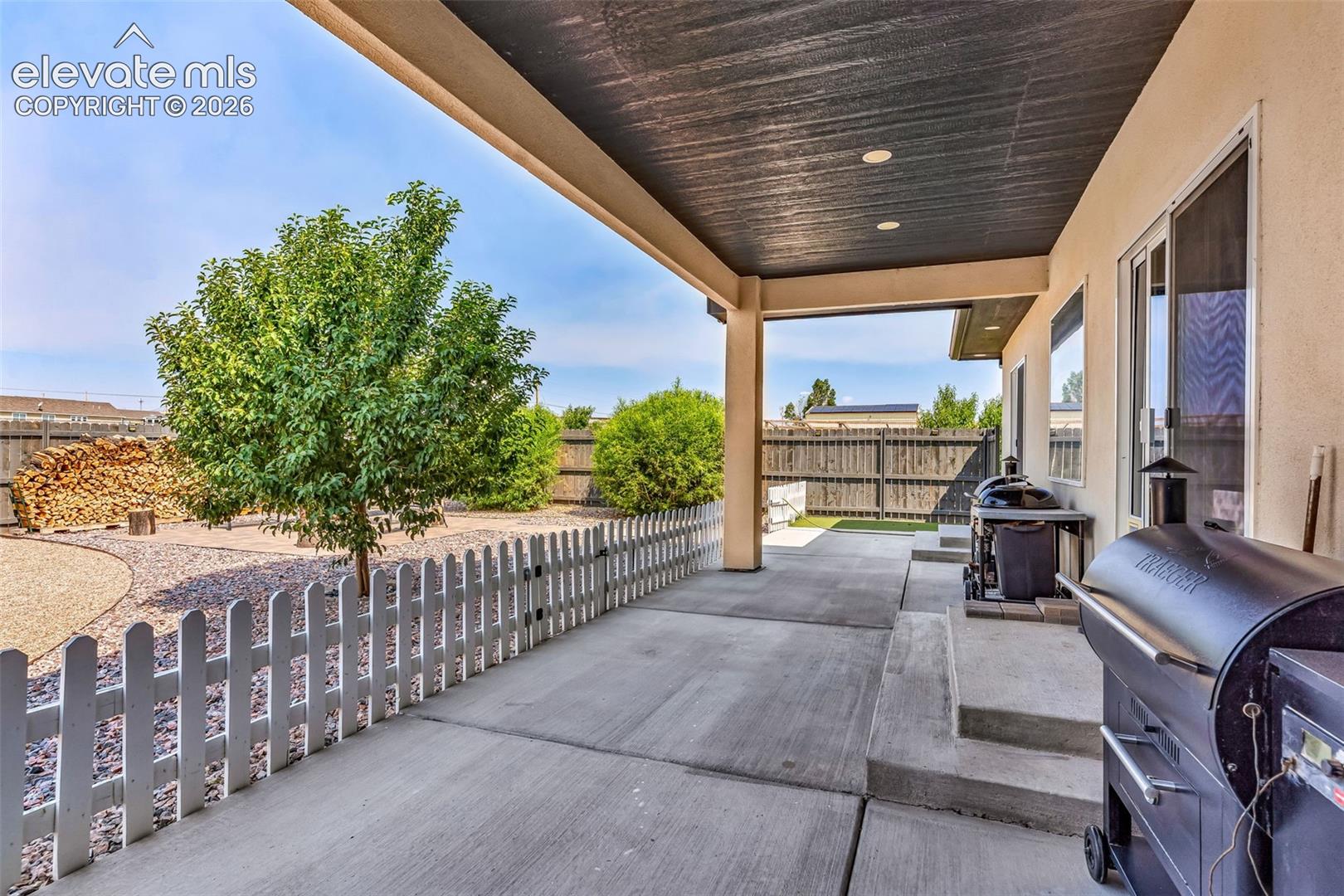 Covered concrete patio with recessed lighting, stucco exterior, and sliding glass door access