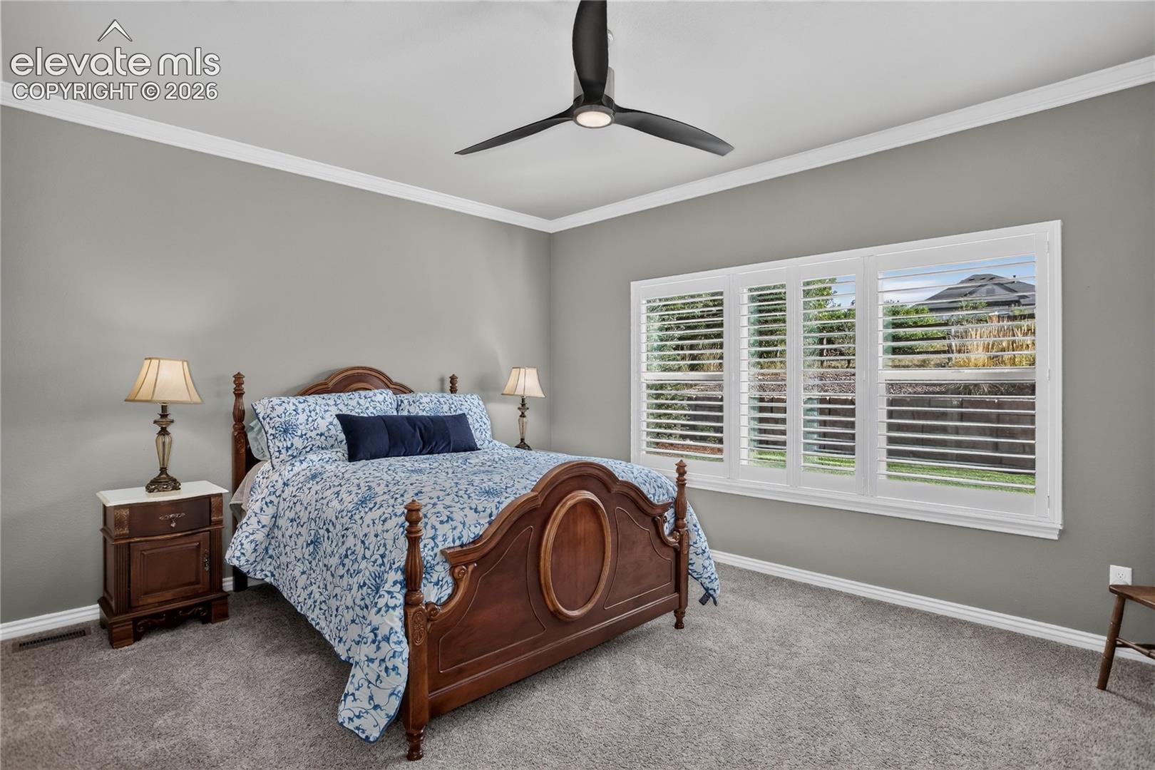 Large primary bedroom w/ crown molding