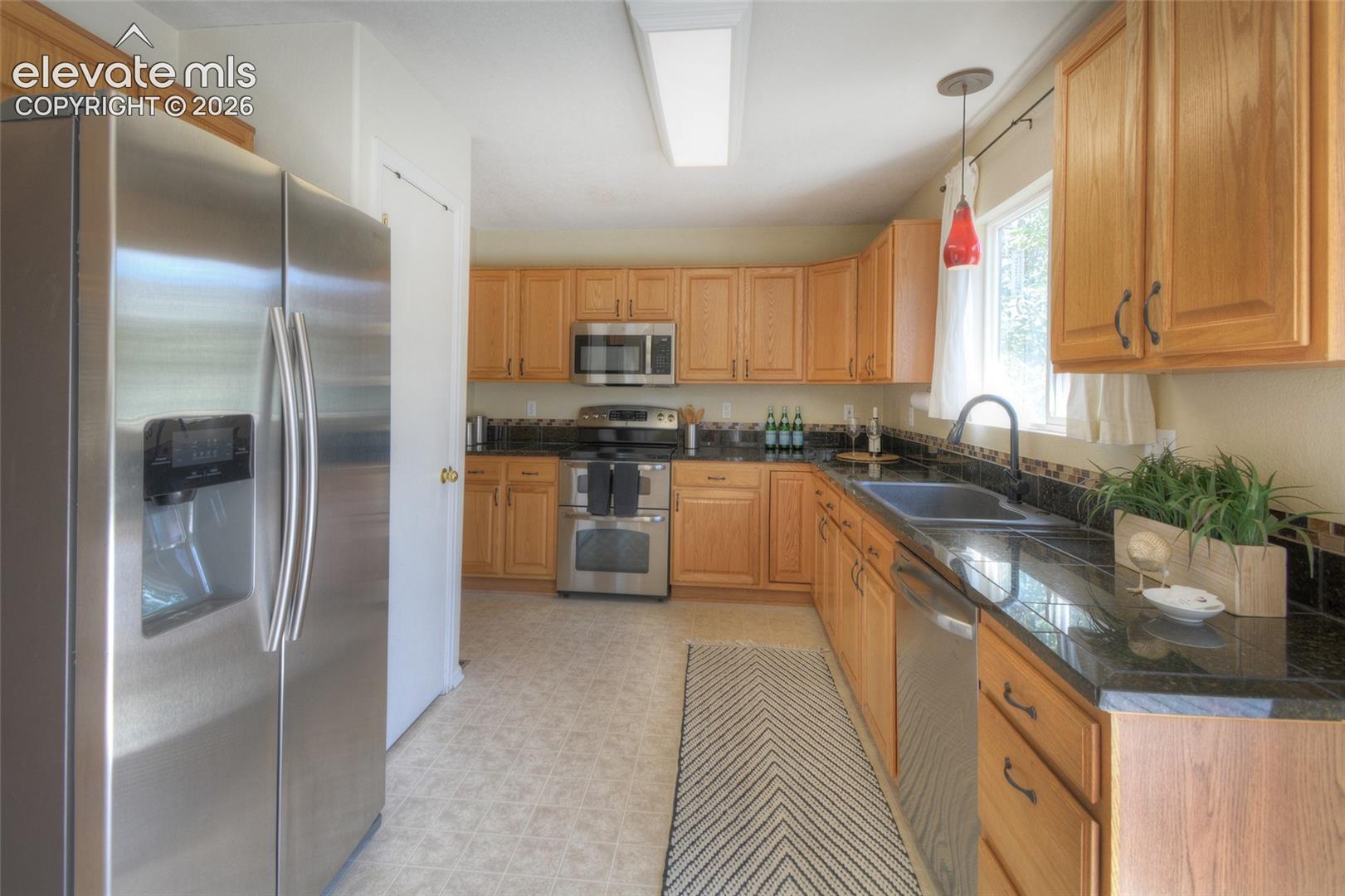 Stainless steel appliances to include a double oven, refrigerator, dishwasher and microwave.