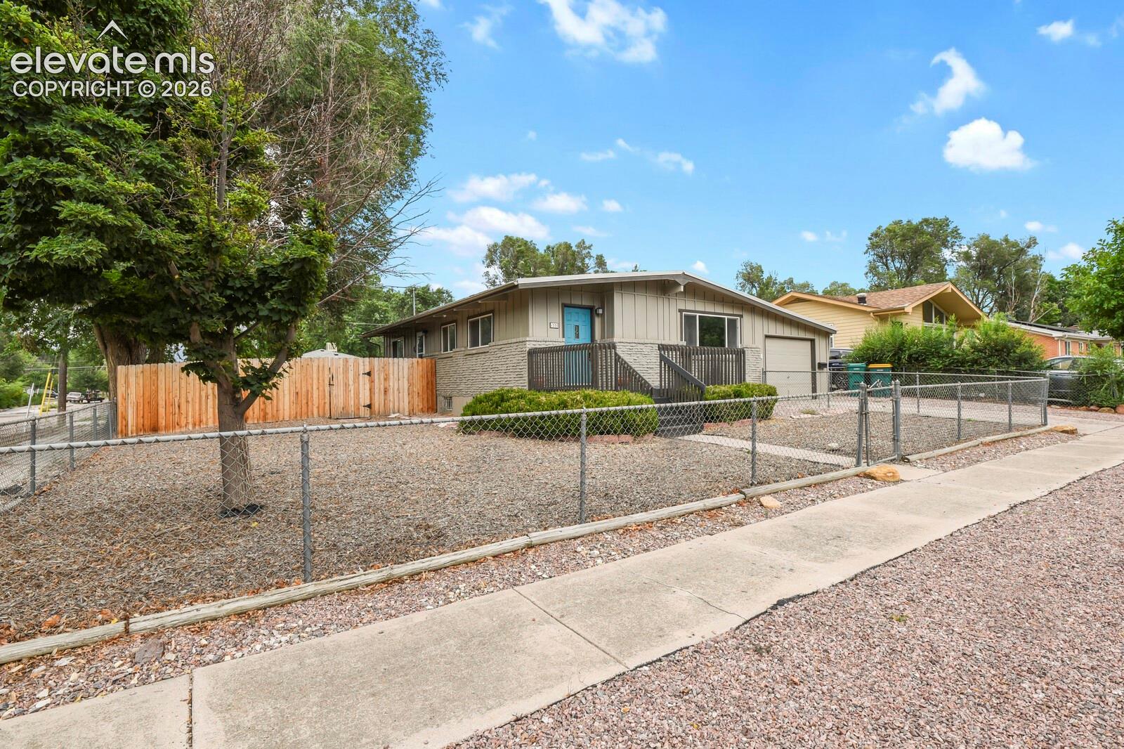 View of front and side yard.  Fully fenced front and back yard.