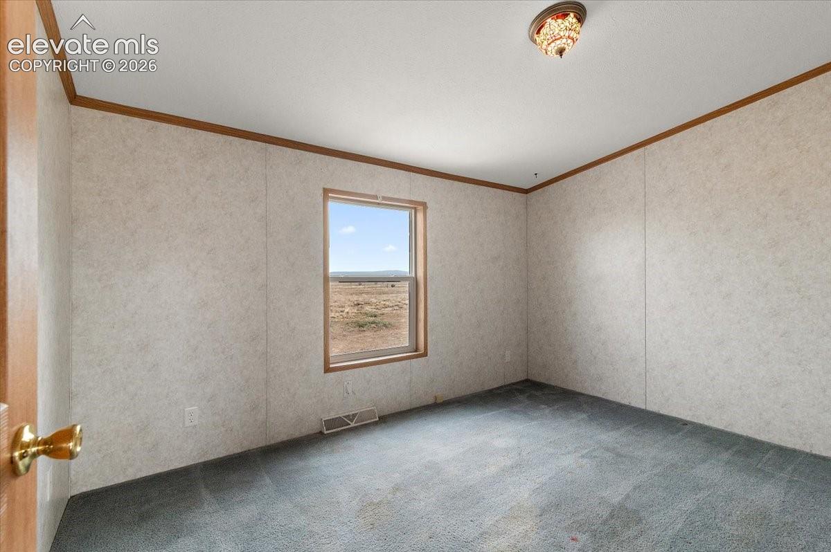 Recessed window with wood-finish trim, ceiling-mounted light fixture, and crown molding