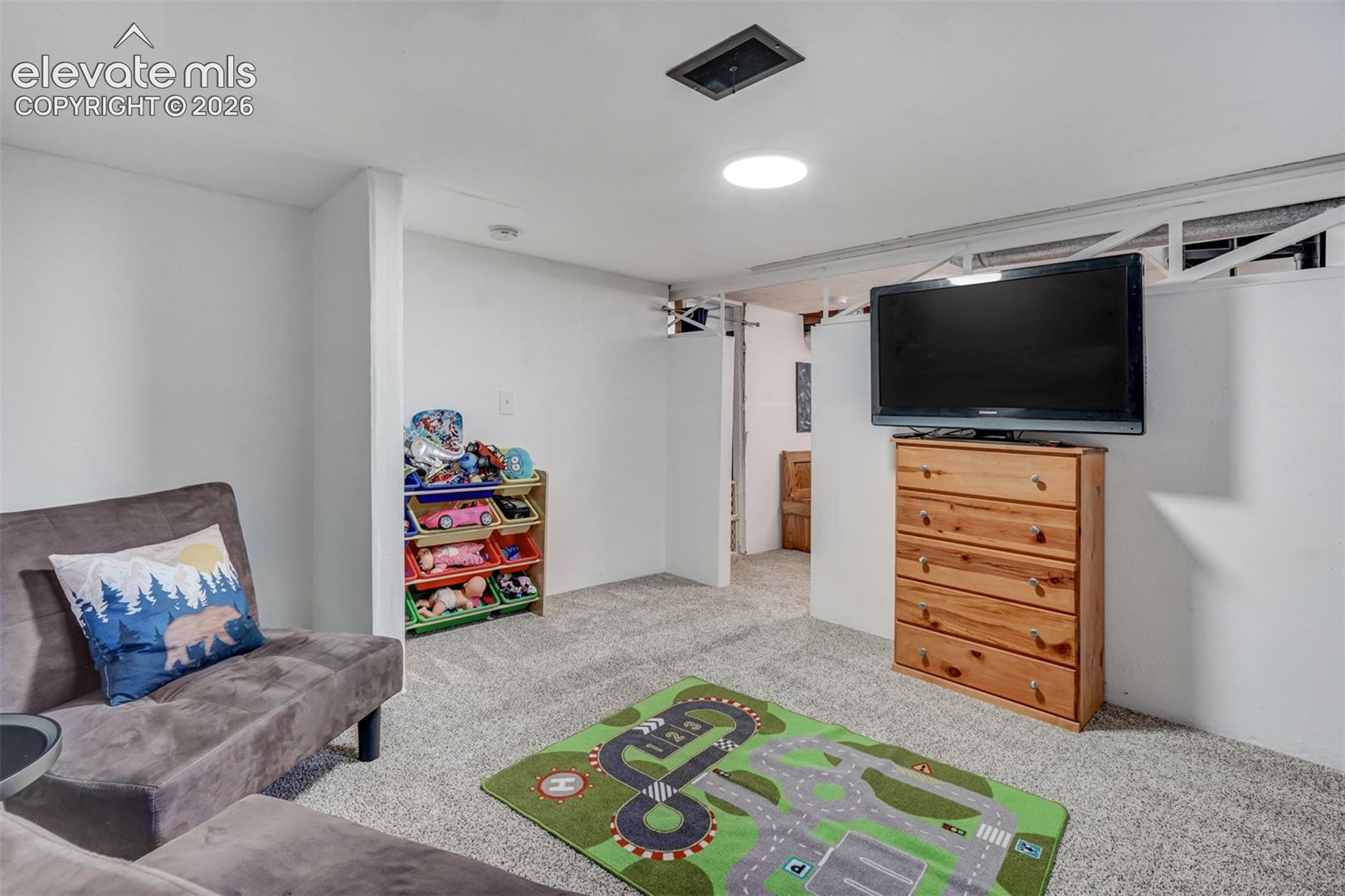 Carpeted flooring, recessed lighting, and white walls